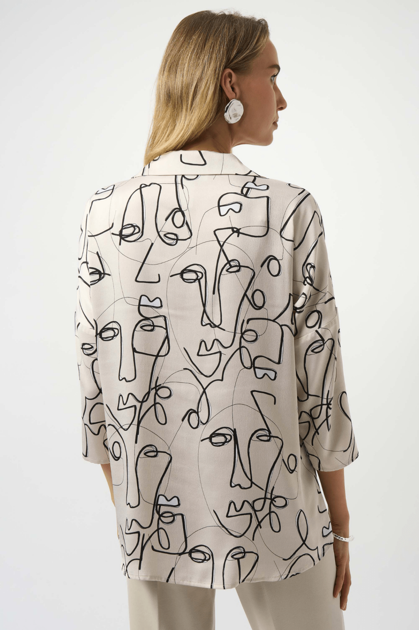 Joseph Ribkoff hammered satin top with abstract face print and pearl buttons – Dotique