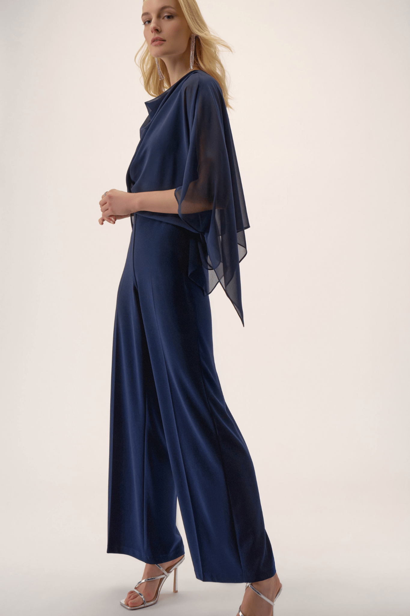 Joseph Ribkoff midnight blue silky knit wide-leg jumpsuit with chiffon poncho overlay and cowl neckline