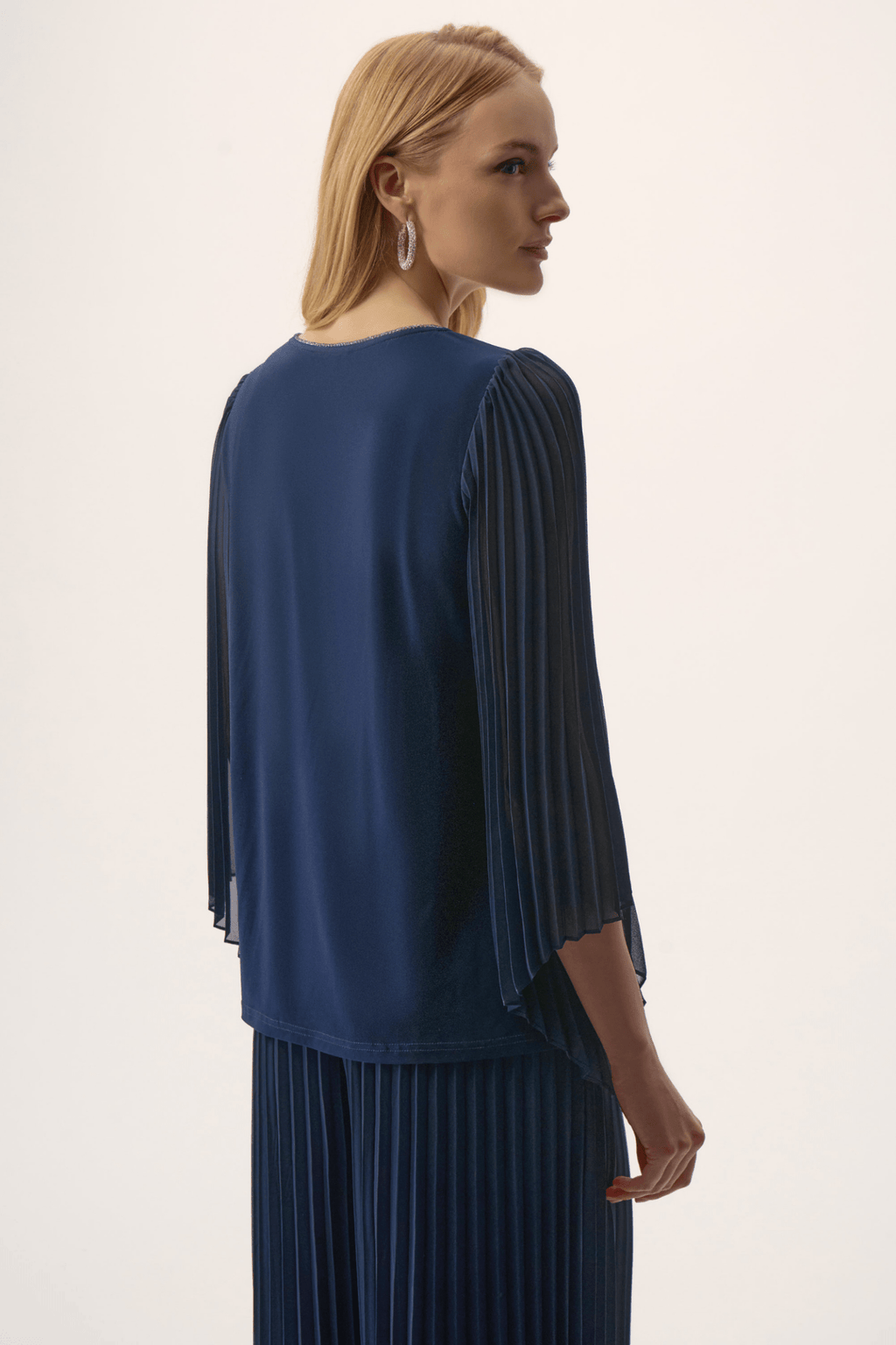 Joseph Ribkoff silky knit top in midnight blue with rhinestone neckline and pleated chiffon bell sleeves