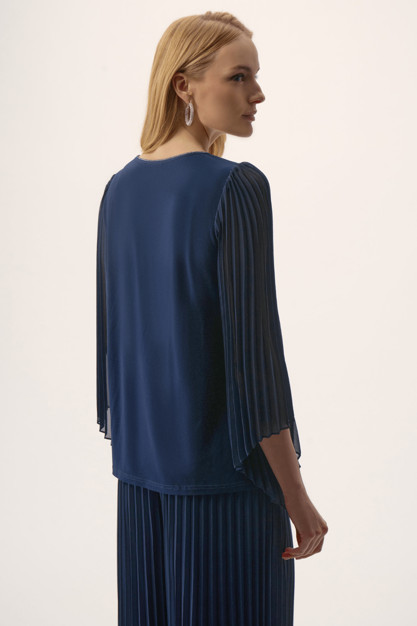 Joseph Ribkoff silky knit top in midnight blue with rhinestone neckline and pleated chiffon bell sleeves