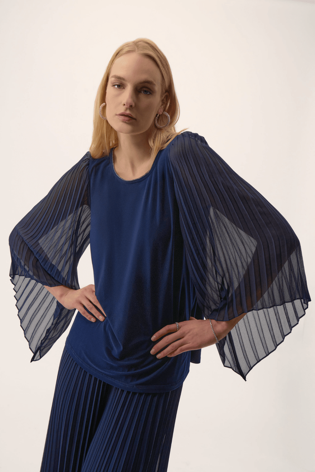 Joseph Ribkoff silky knit top in midnight blue with rhinestone neckline and pleated chiffon bell sleeves