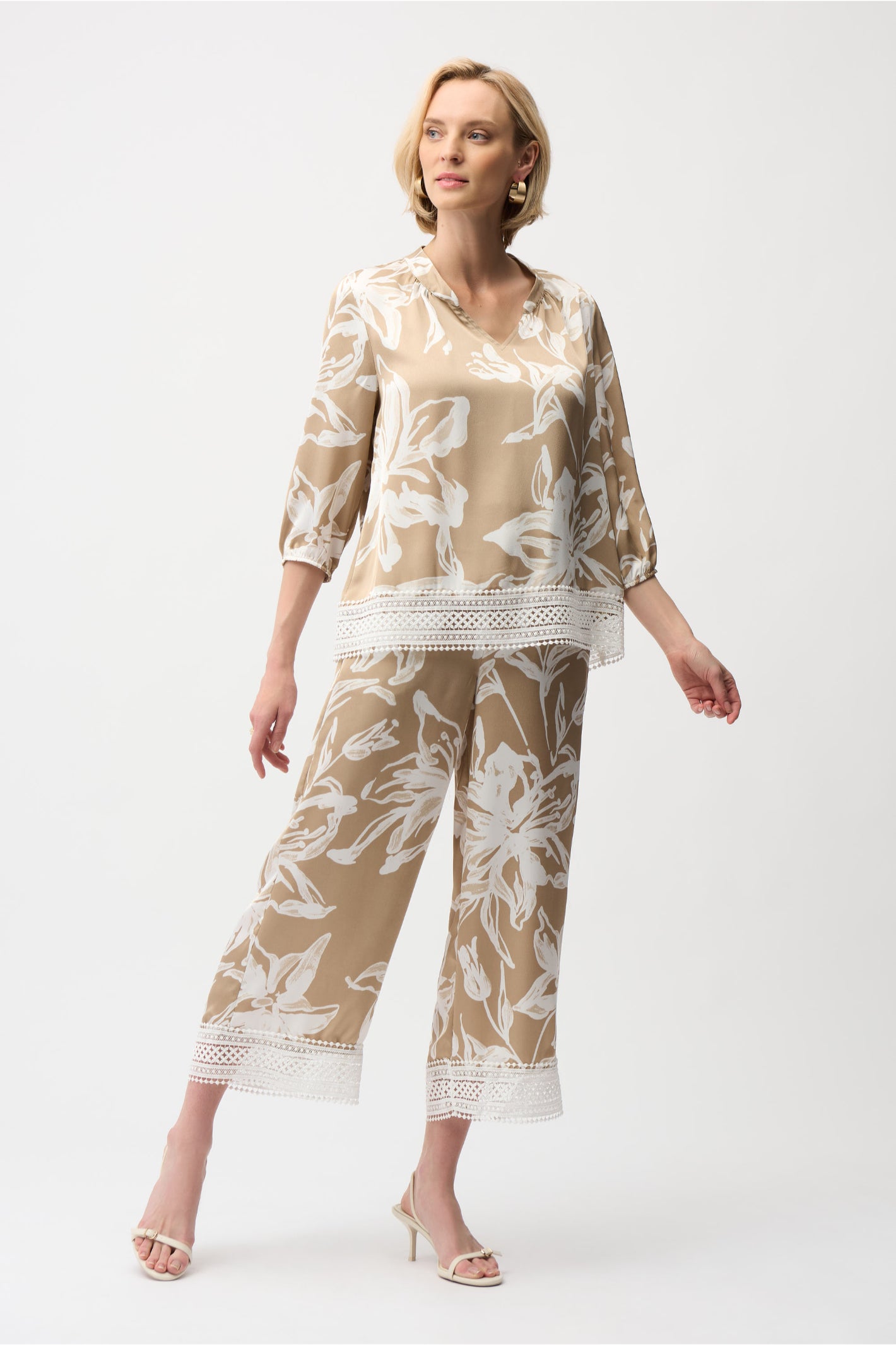 Model wearing Joseph Ribkoff 261023 Recycled Satin Floral Print Pull-On Culotte Pants in beige with white floral print, shop Joseph Ribkoff at Dotique.