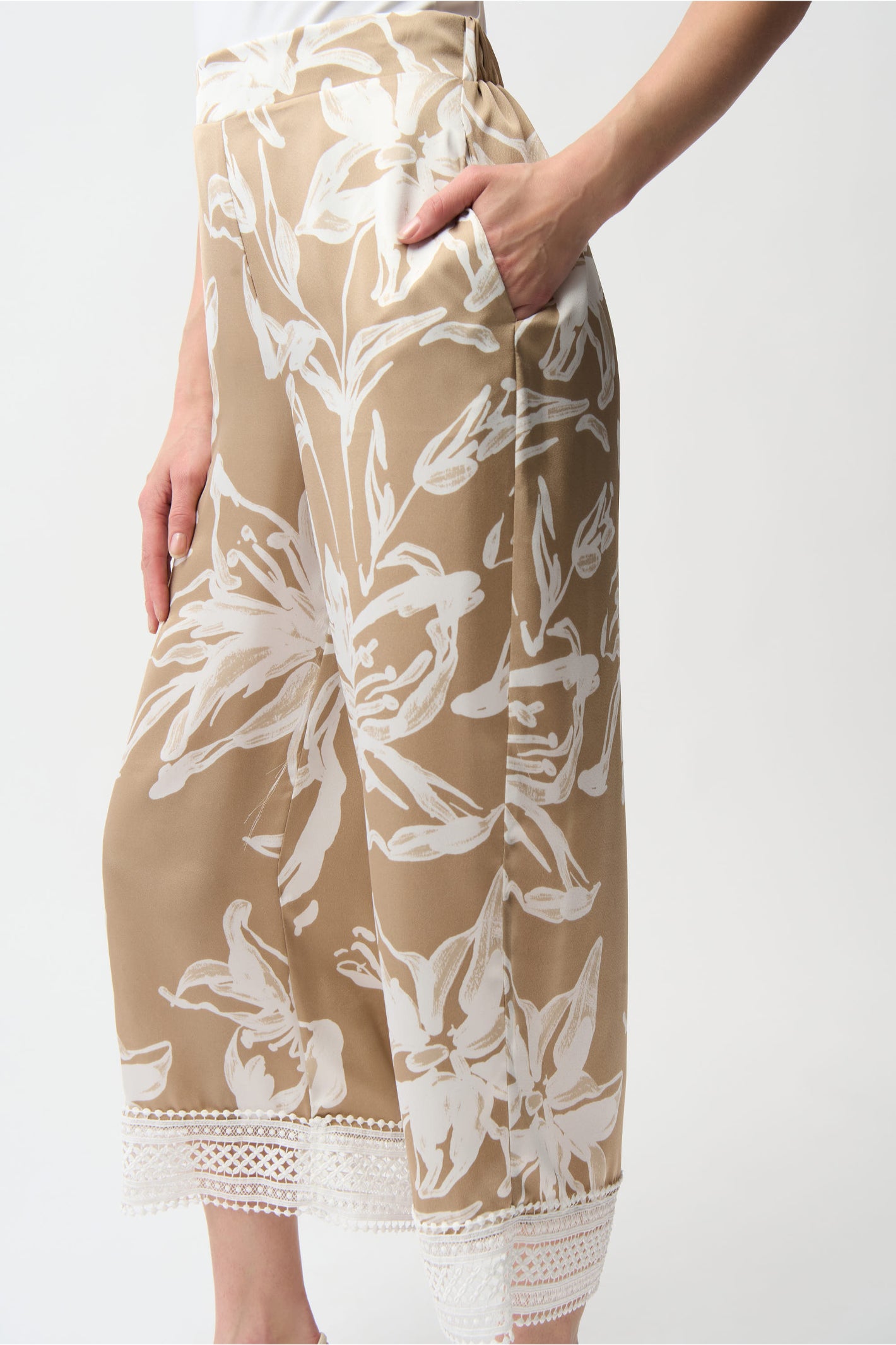 Close-up of beige and white floral print culotte pants with lace trim hem, Joseph Ribkoff 261023 Recycled Satin Floral Print Pull-On Culotte Pants by Joseph Ribkoff, shop Joseph Ribkoff at Dotique.