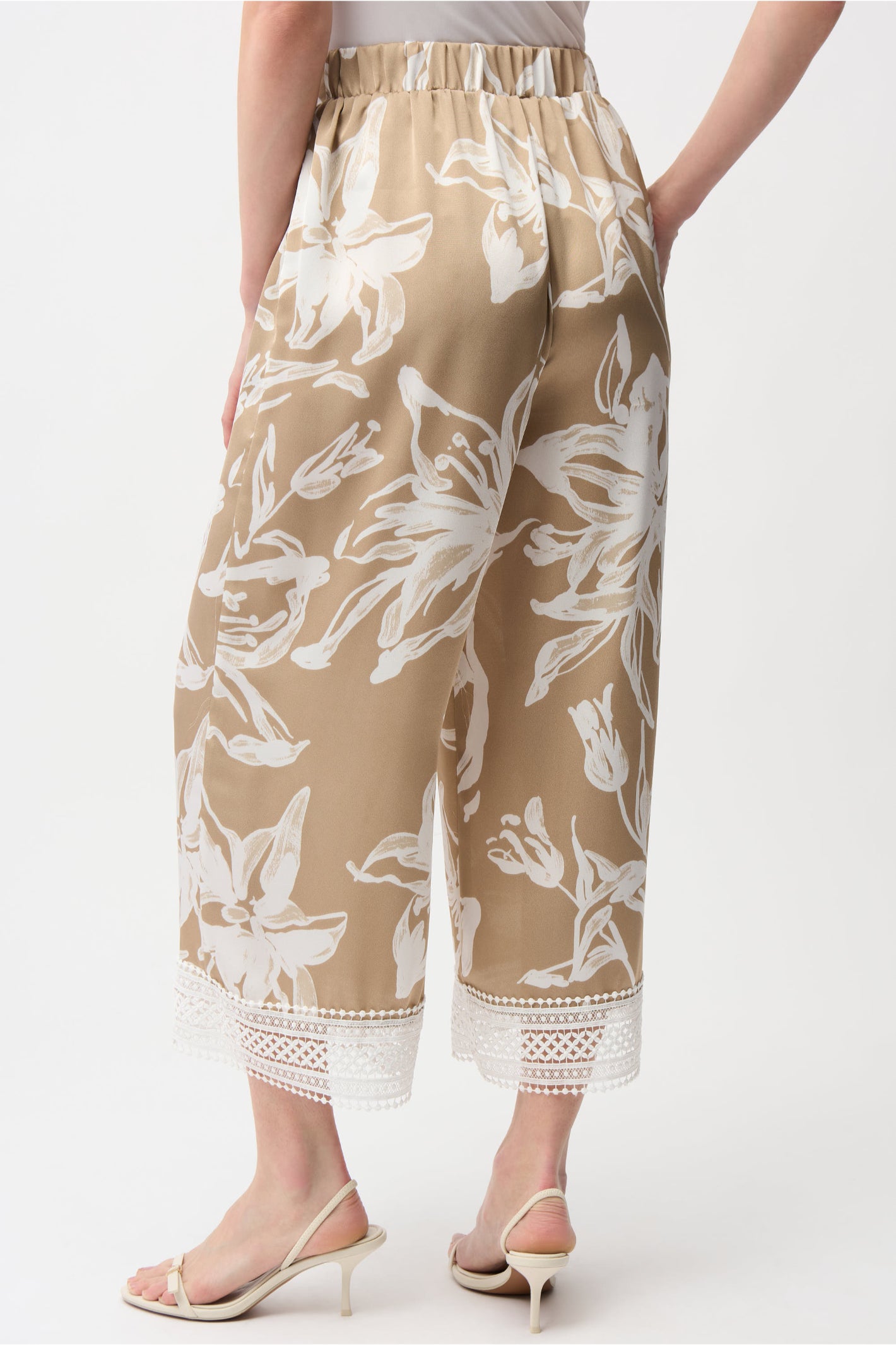 Back view of Joseph Ribkoff 261023 Recycled Satin Floral Print Pull-On Culotte Pants in beige with white floral design and lace hem by Joseph Ribkoff, shop Joseph Ribkoff at Dotique.
