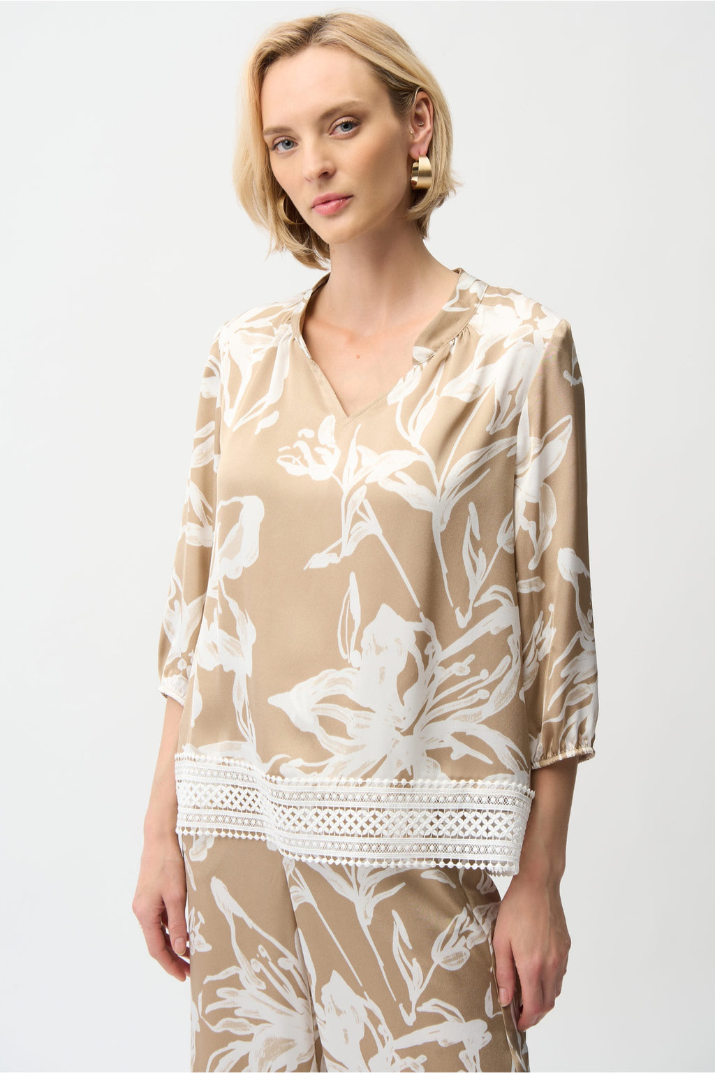 Model wearing Joseph Ribkoff 261031 Satin Floral Print Straight Top With Mandarin Collar featuring a beige and white floral pattern, shop Joseph Ribkoff at Dotique.