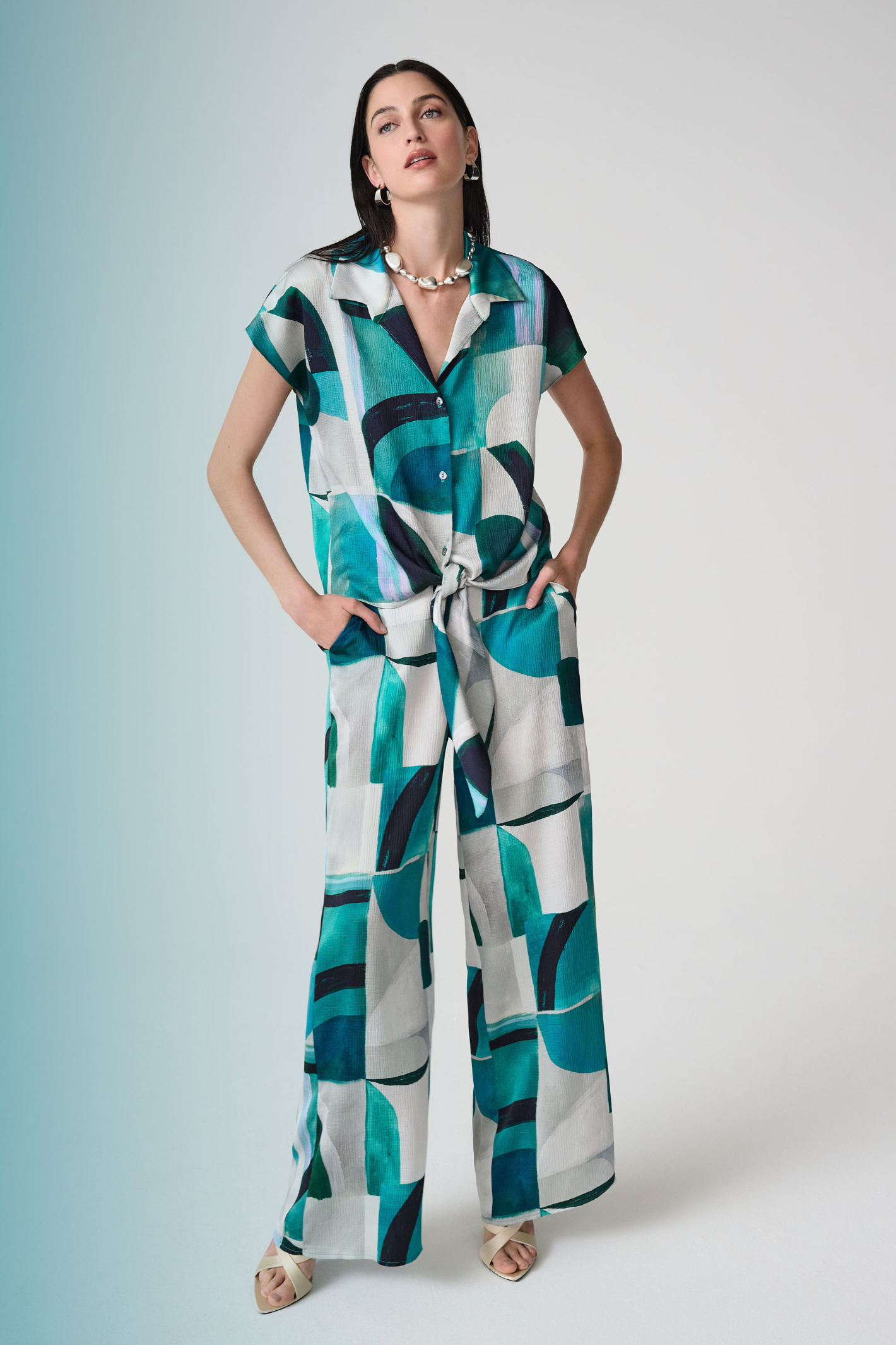 Statement wide leg trousers by Joseph Ribkoff in textured satin with a bold geometric print. Easy pull-on fit with pockets. Shop now at Dotique.