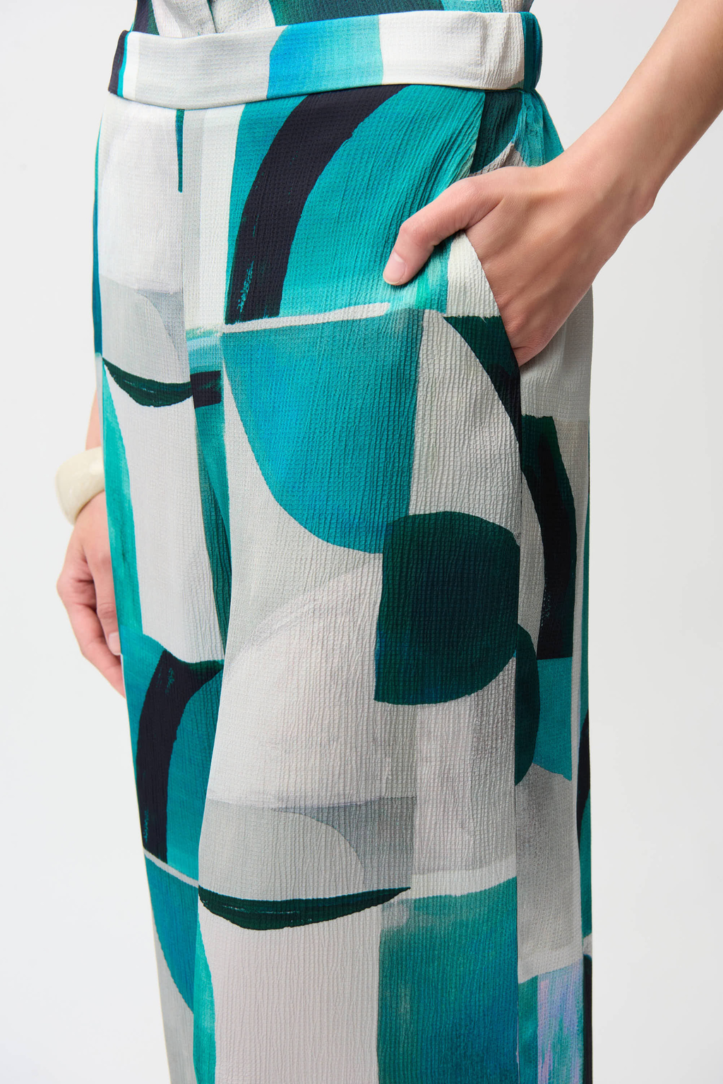 Statement wide leg trousers by Joseph Ribkoff in textured satin with a bold geometric print. Easy pull-on fit with pockets. Shop now at Dotique.