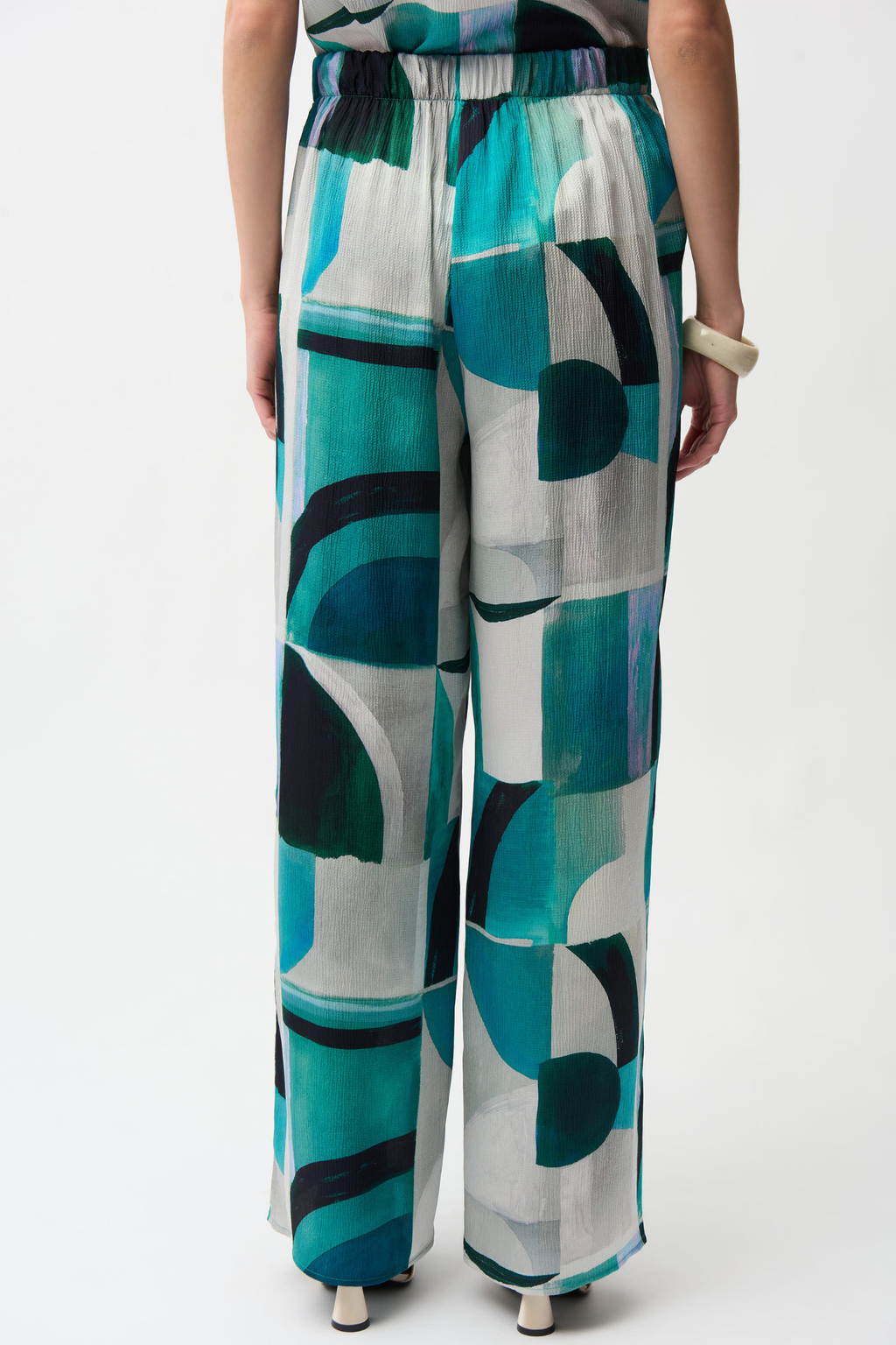 Statement wide leg trousers by Joseph Ribkoff in textured satin with a bold geometric print. Easy pull-on fit with pockets. Shop now at Dotique.