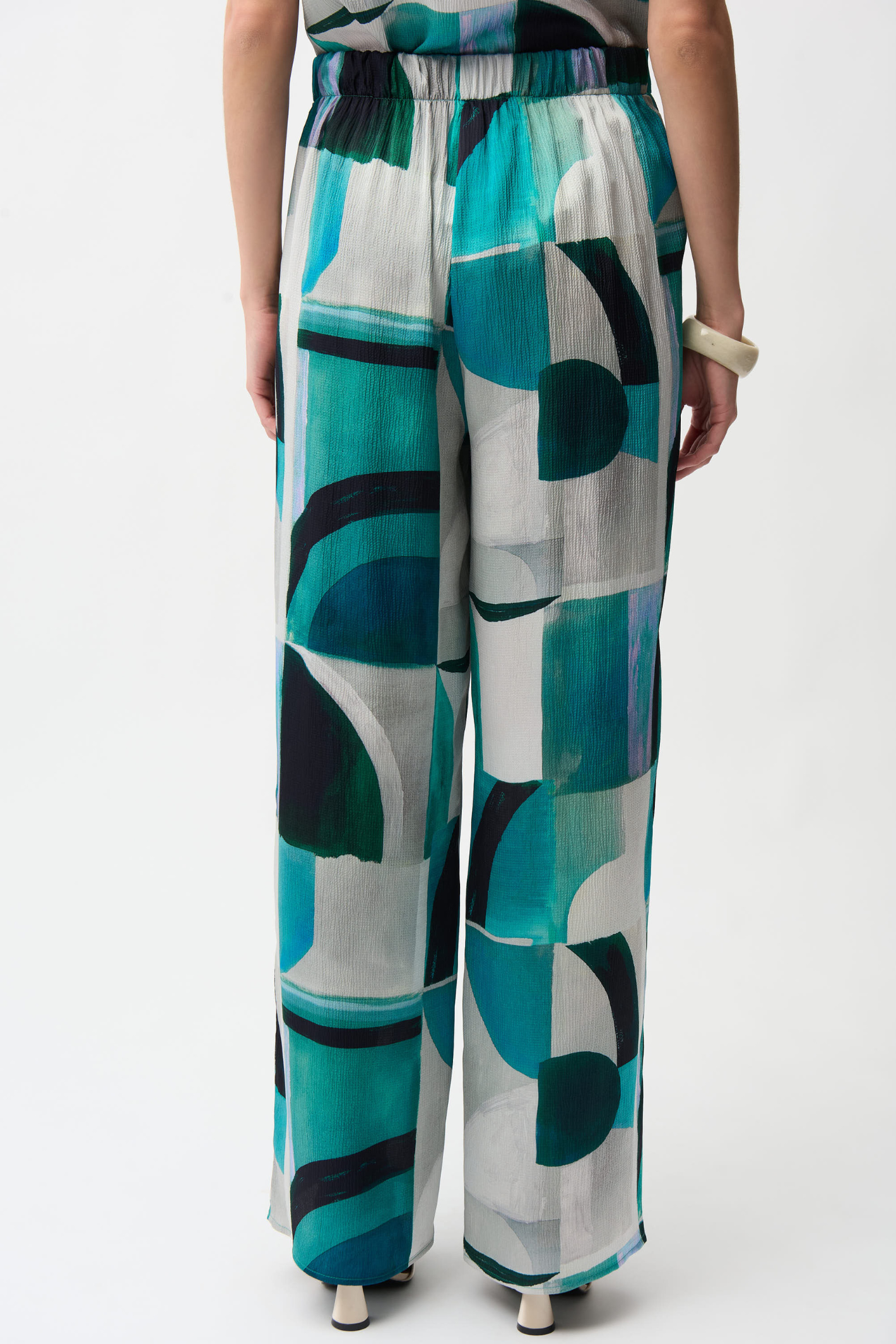Statement wide leg trousers by Joseph Ribkoff in textured satin with a bold geometric print. Easy pull-on fit with pockets. Shop now at Dotique.