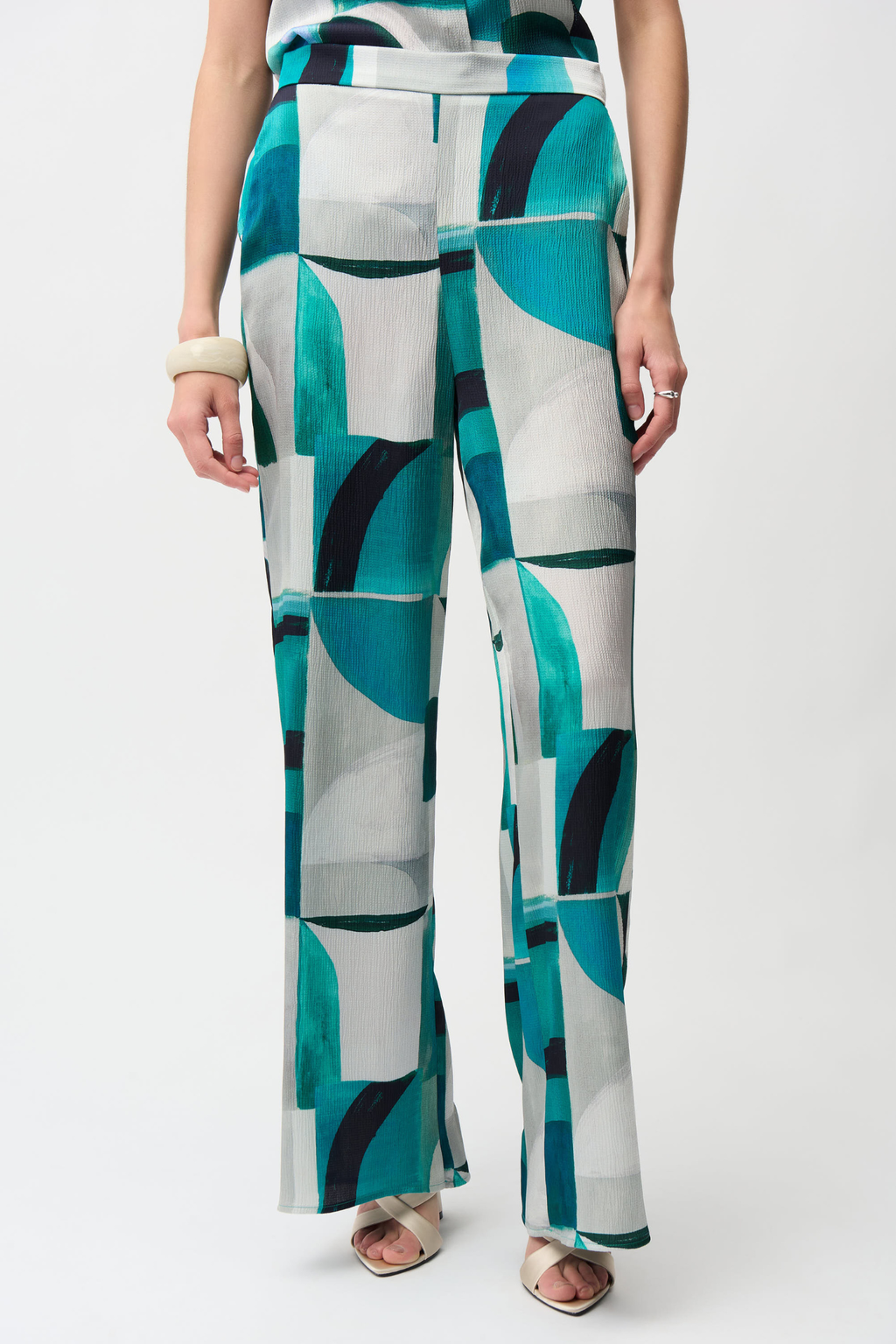 Statement wide leg trousers by Joseph Ribkoff in textured satin with a bold geometric print. Easy pull-on fit with pockets. Shop now at Dotique.