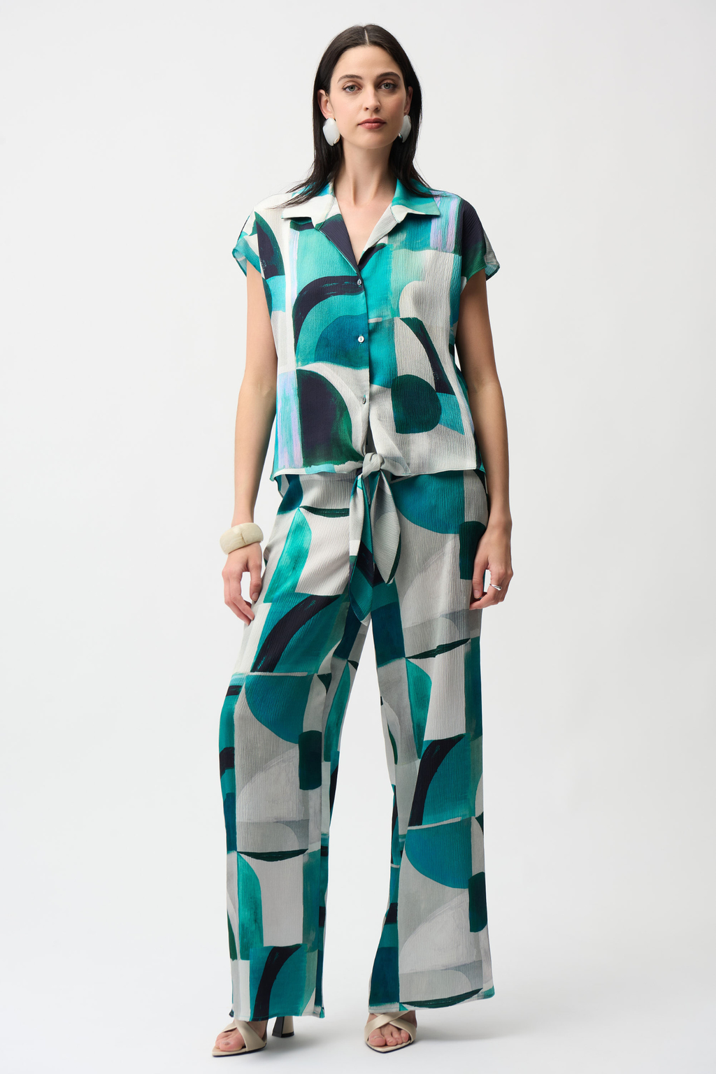 Statement wide leg trousers by Joseph Ribkoff in textured satin with a bold geometric print. Easy pull-on fit with pockets. Shop now at Dotique.
