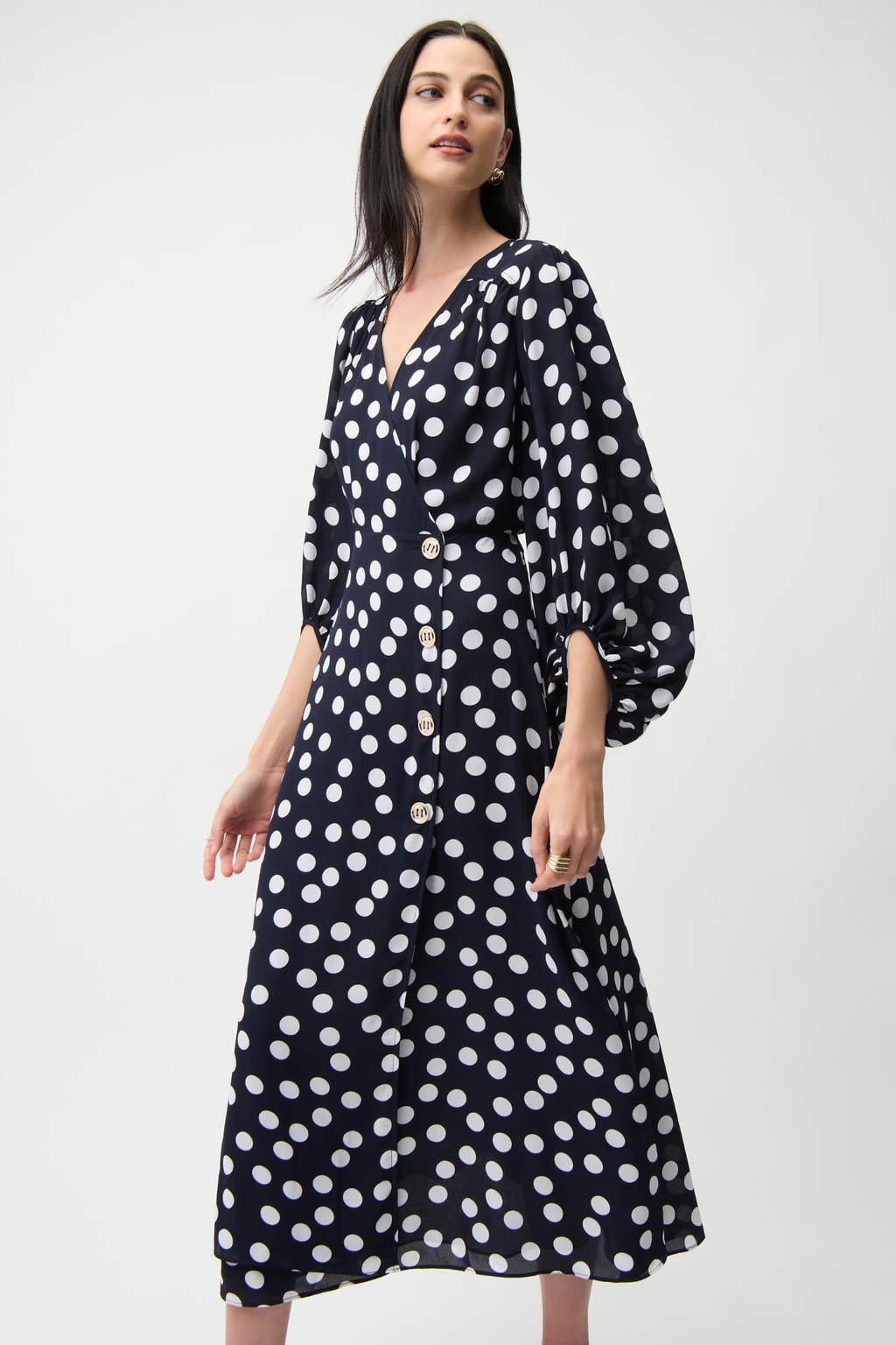 Joseph Ribkoff 261901 georgette polka dot wrap dress with puff sleeves and midi skirt. Flattering, elegant and easy to wear. Shop Dotique.