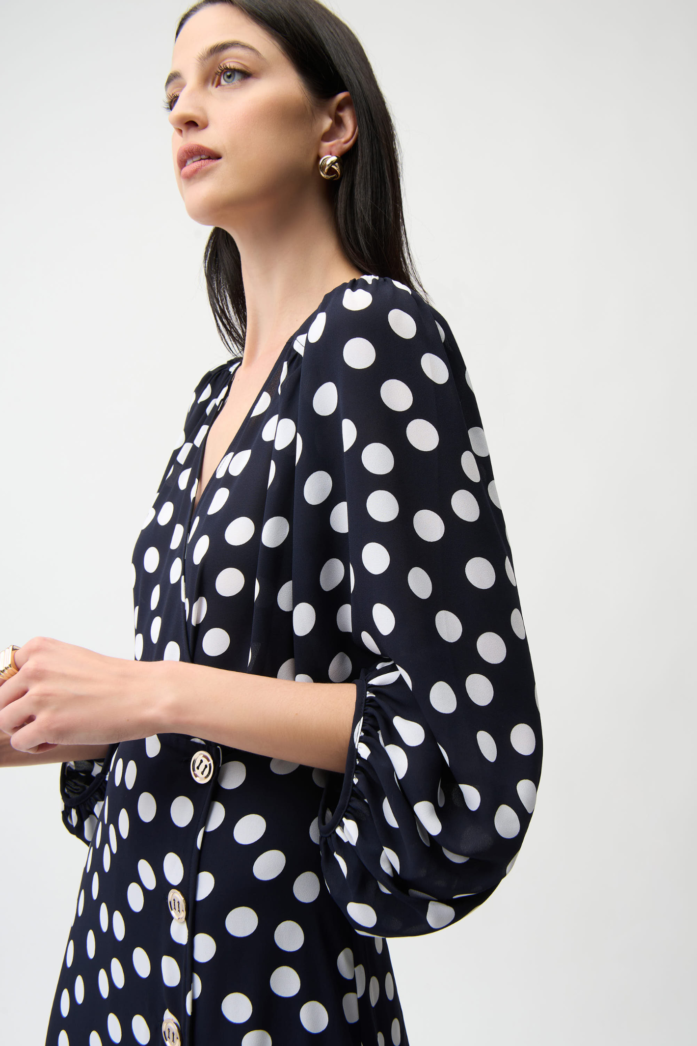 Joseph Ribkoff 261901 georgette polka dot wrap dress with puff sleeves and midi skirt. Flattering, elegant and easy to wear. Shop Dotique.