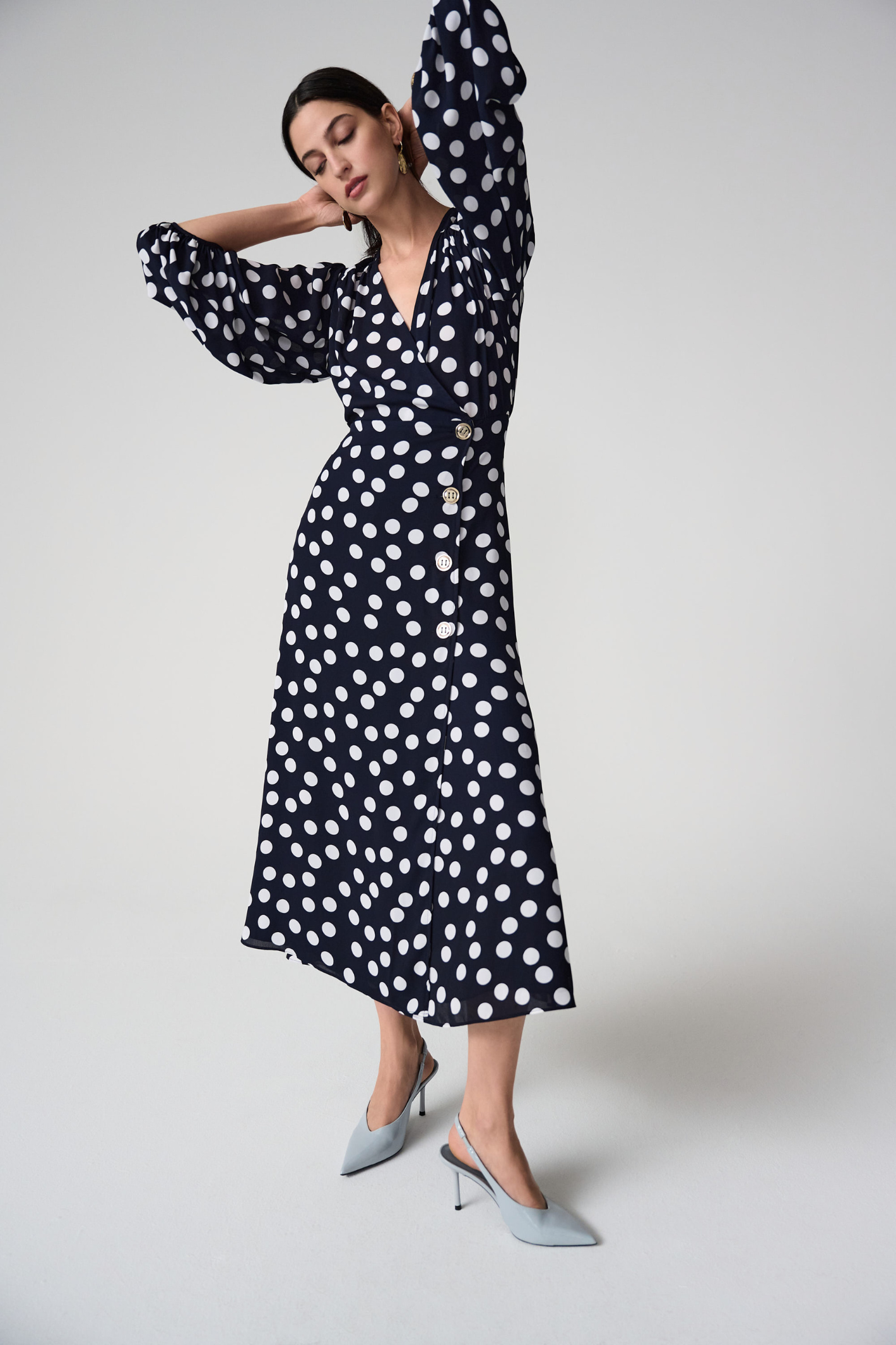 Joseph Ribkoff 261901 georgette polka dot wrap dress with puff sleeves and midi skirt. Flattering, elegant and easy to wear. Shop Dotique.