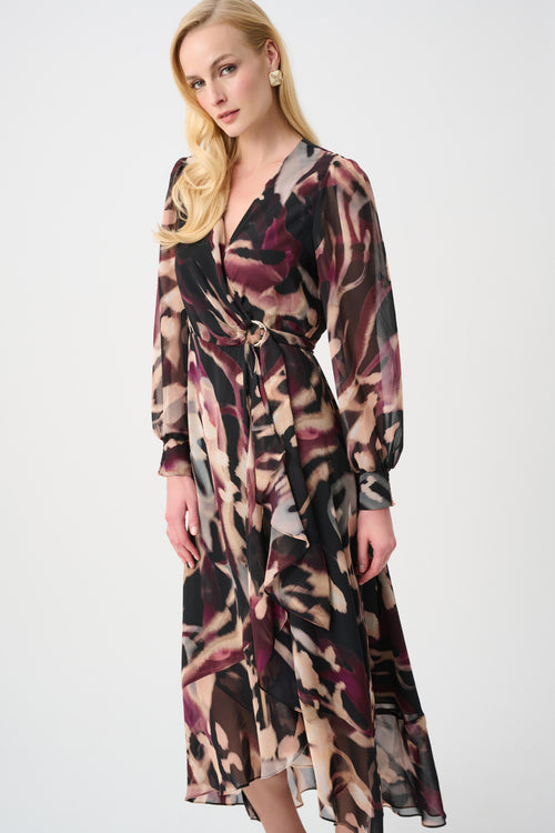 Woman wearing a long sheer abstract print wrap dress