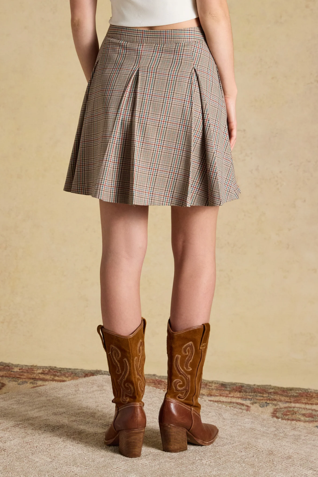Shop the Joules Ada Short Pleated Skirt in Swindale Tweed. A heritage check mini with structured pleats, tailored waist and concealed side zip.