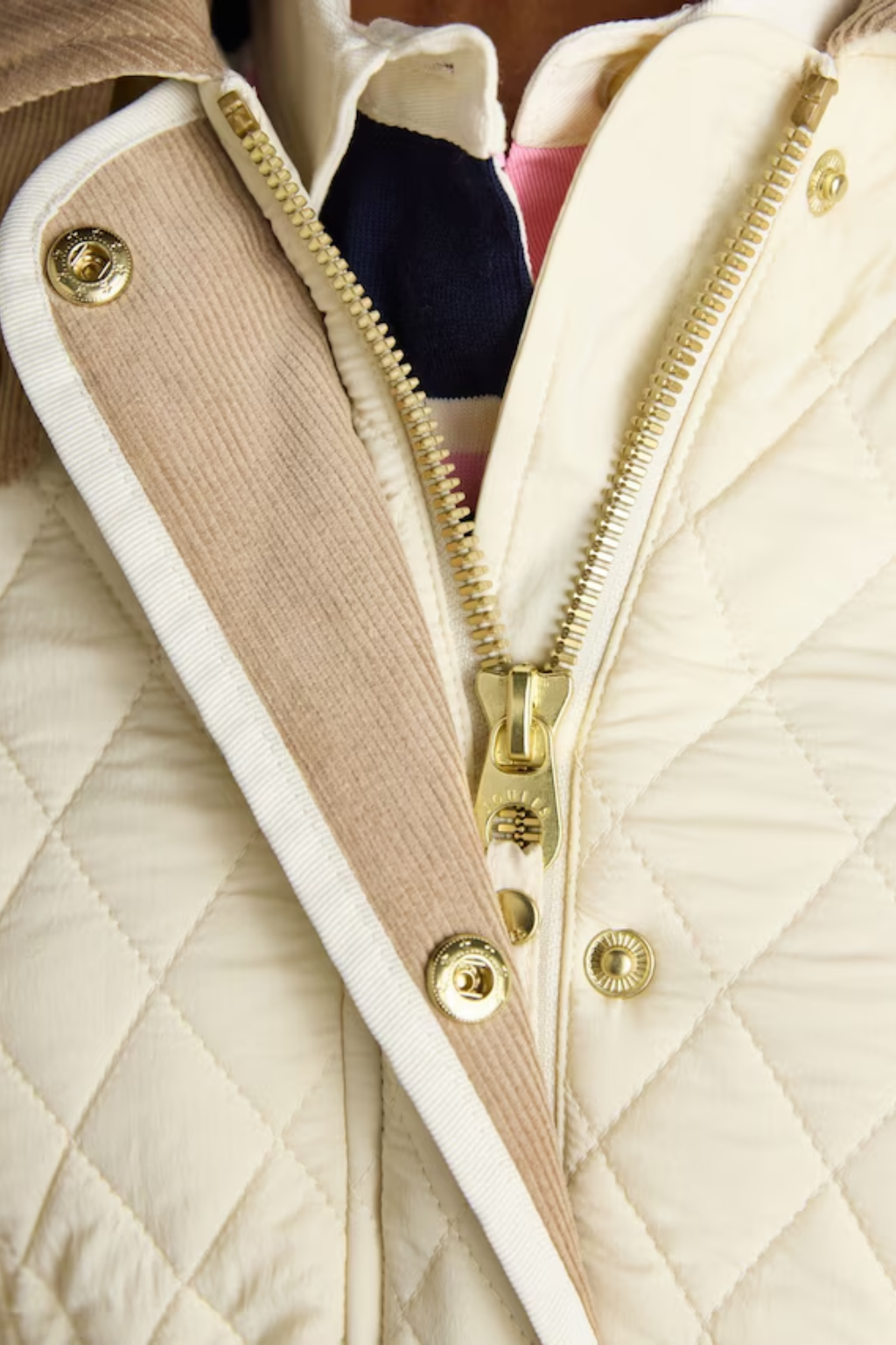 Shop the Joules Highclere showerproof diamond quilted jacket — a stylish and practical layer with cord collar, welt pockets and adjustable waist, perfect for rainy days. Shop Joules at Dotique.