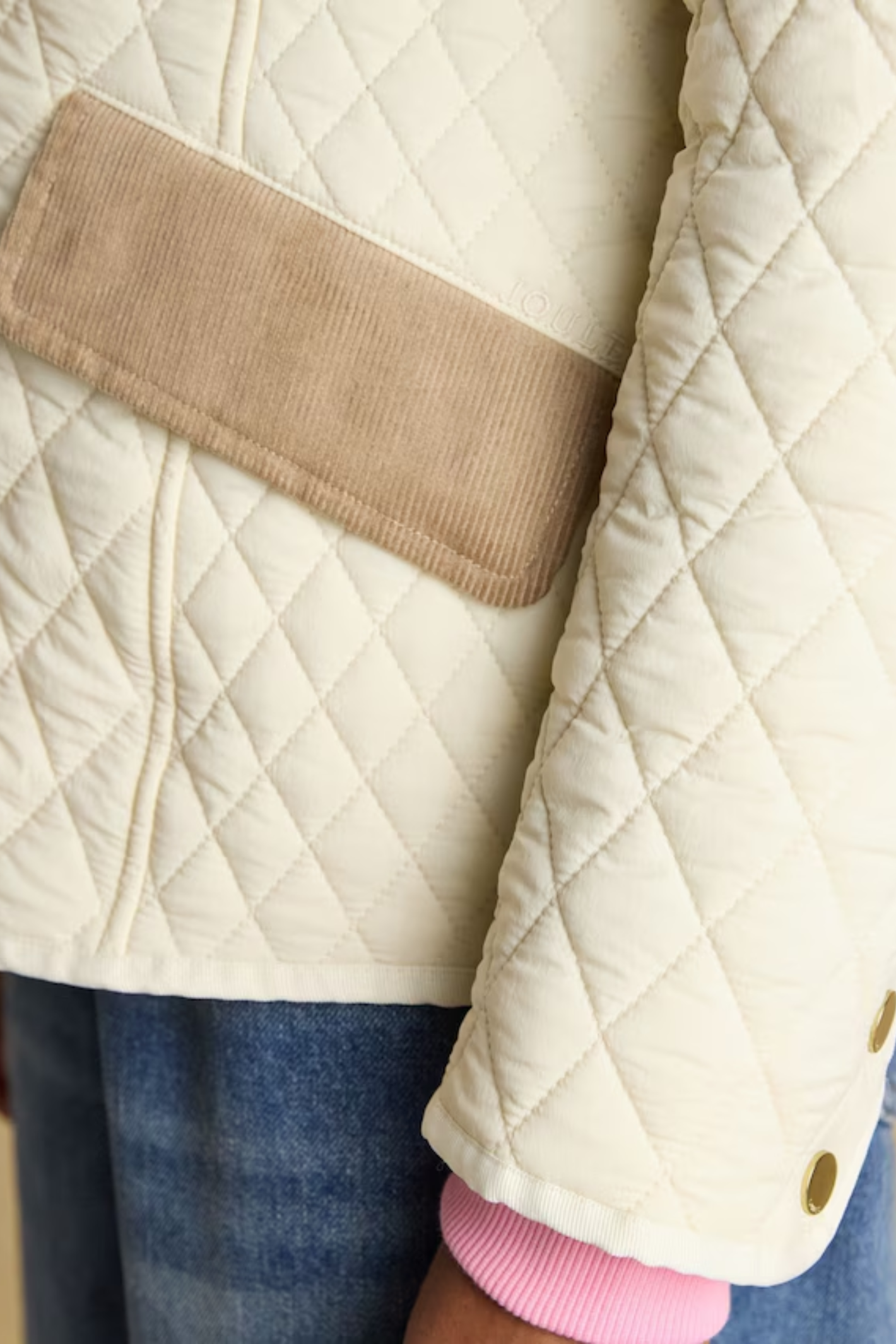 Shop the Joules Highclere showerproof diamond quilted jacket — a stylish and practical layer with cord collar, welt pockets and adjustable waist, perfect for rainy days. Shop Joules at Dotique.