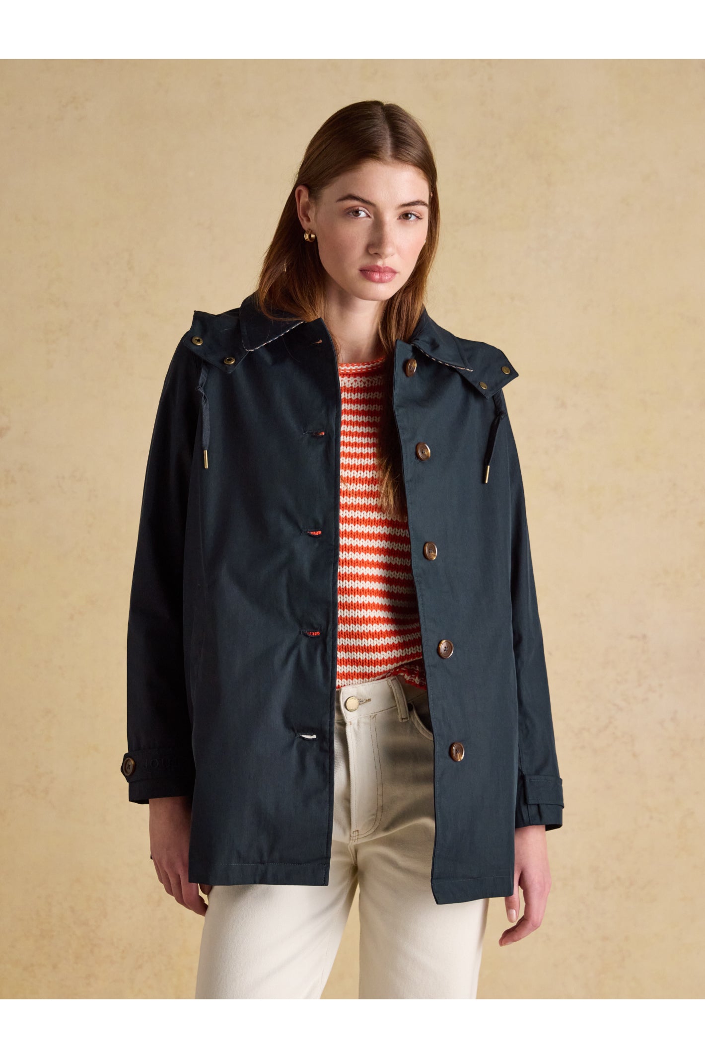 Woman wearing Joules H23721 Rainmore Waterproof Coat – Navy by Joules, shop the brand at Dotique for stylish outerwear.