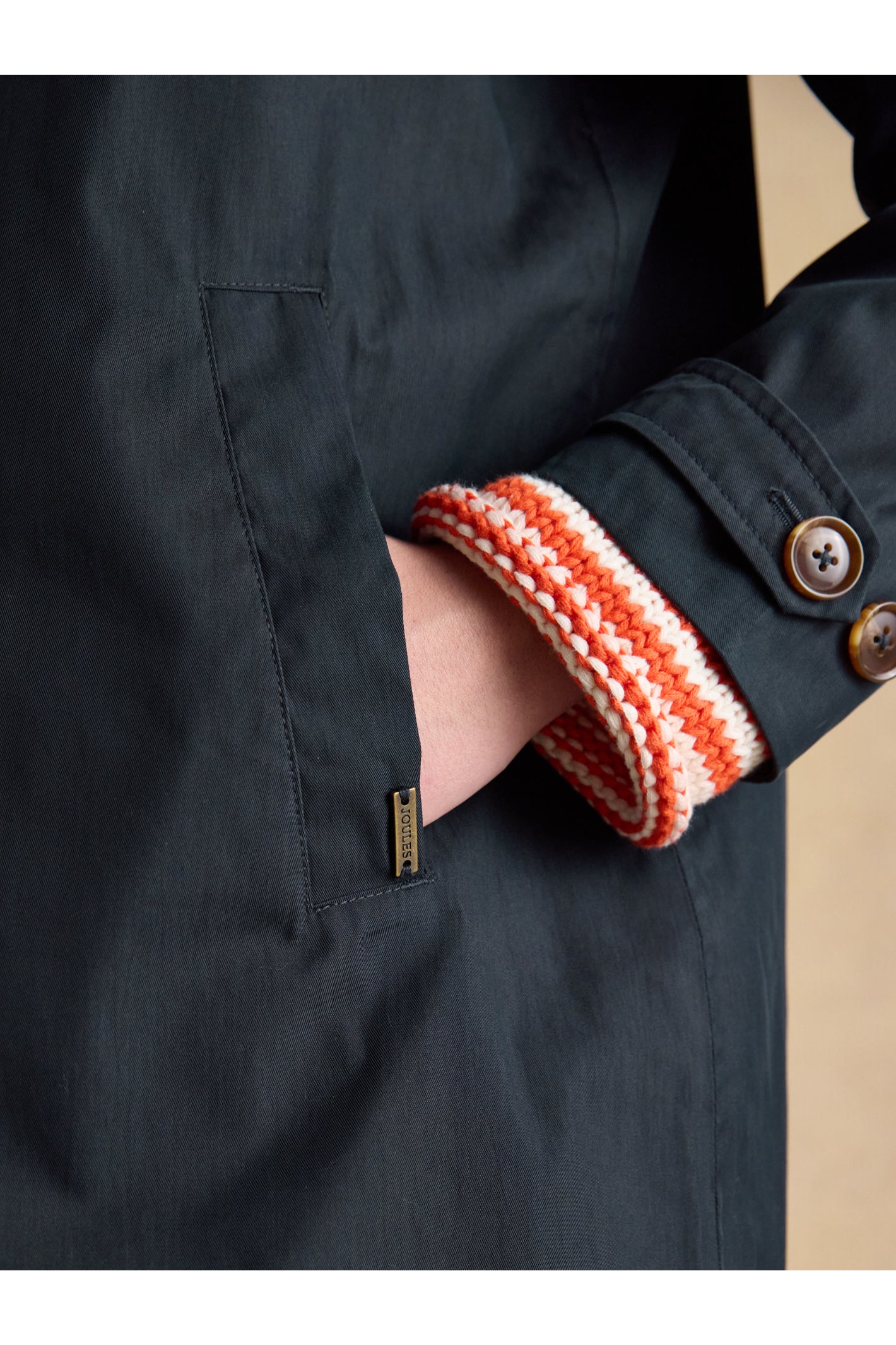 Close-up of hand in pocket on Joules H23721 Rainmore Waterproof Coat – Navy by Joules, shop Joules at Dotique