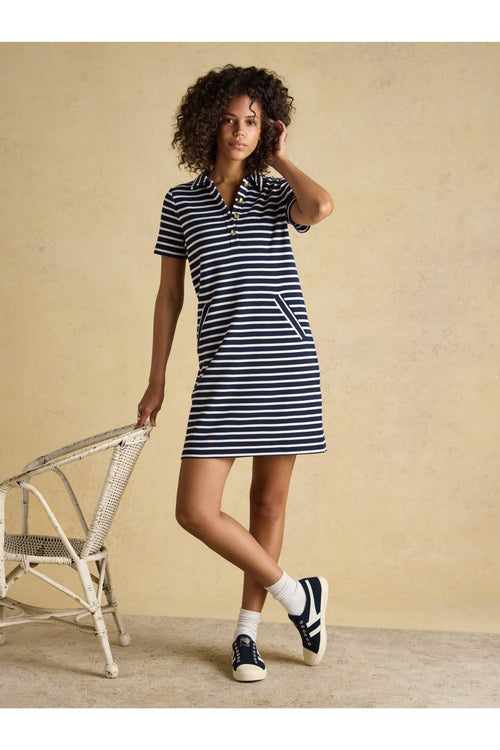Model wearing Joules H63471 Jane Collared Dress – Navy Stripe with short sleeves and front pockets by Joules. Shop Joules at Dotique.