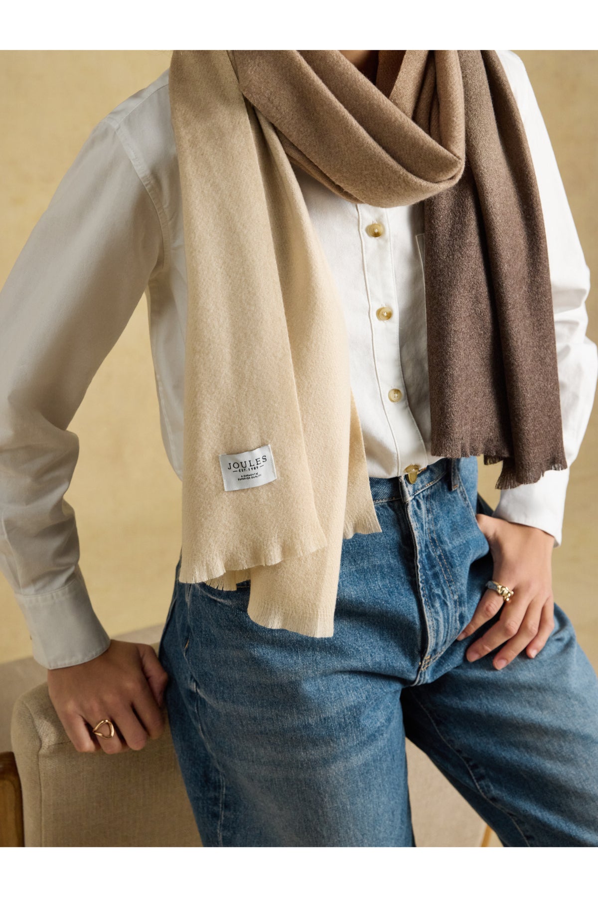 Joules Karina Brown Scarf worn by a model in neutral tones. Shop Joules at Dotique