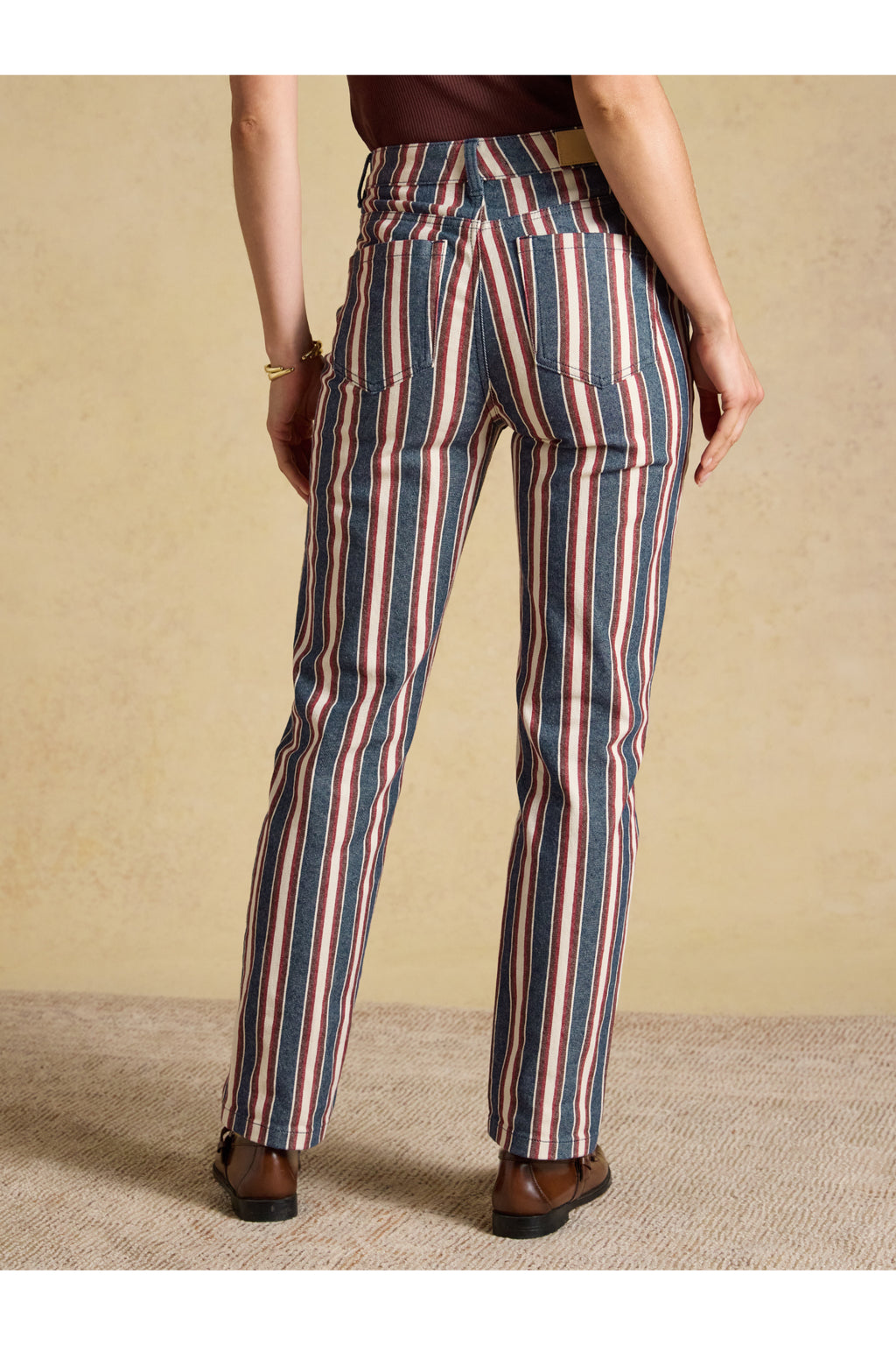 Joules Navy Verigated Stripe Slim Straight Mid Rise Jeans worn by a model. Shop Joules at Dotique