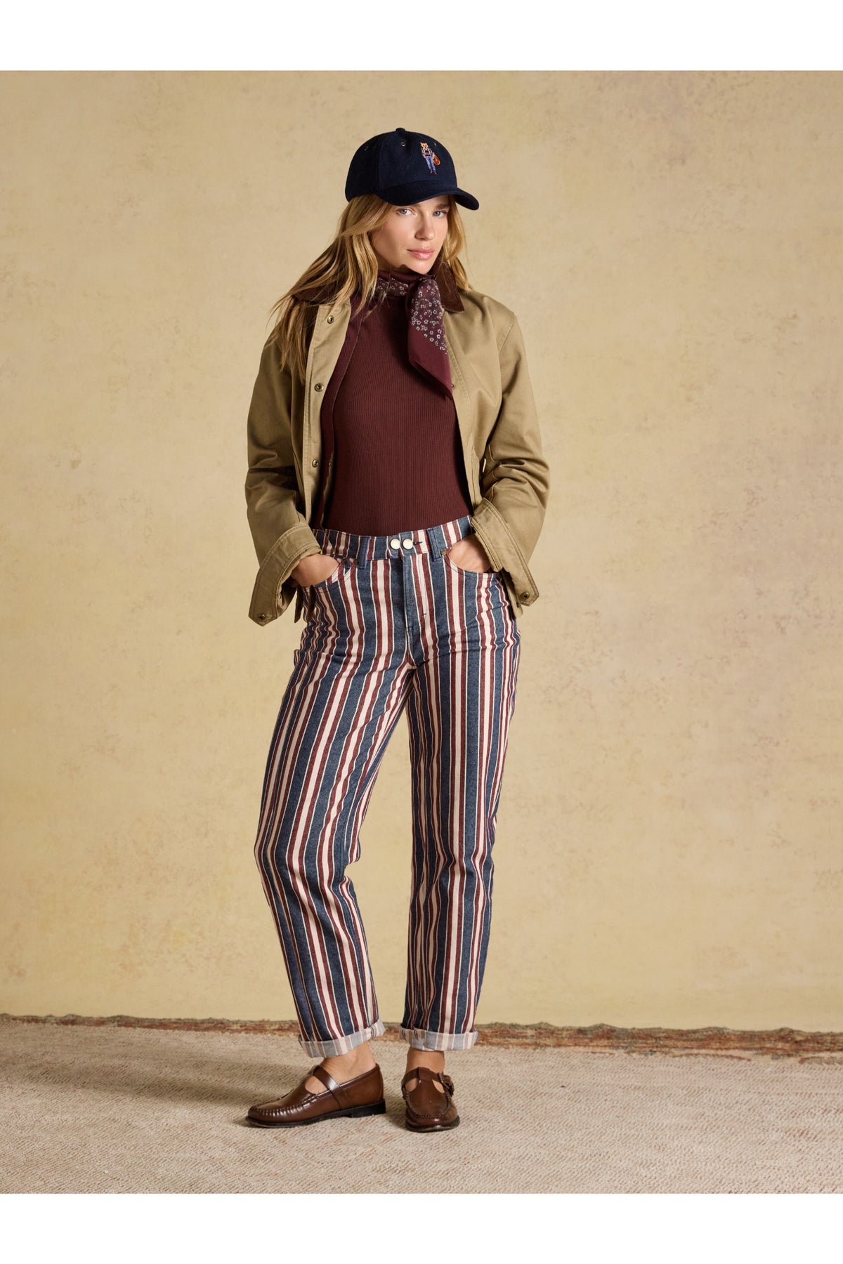 Joules Navy Verigated Stripe Slim Straight Mid Rise Jeans worn by a model. Shop Joules at Dotique