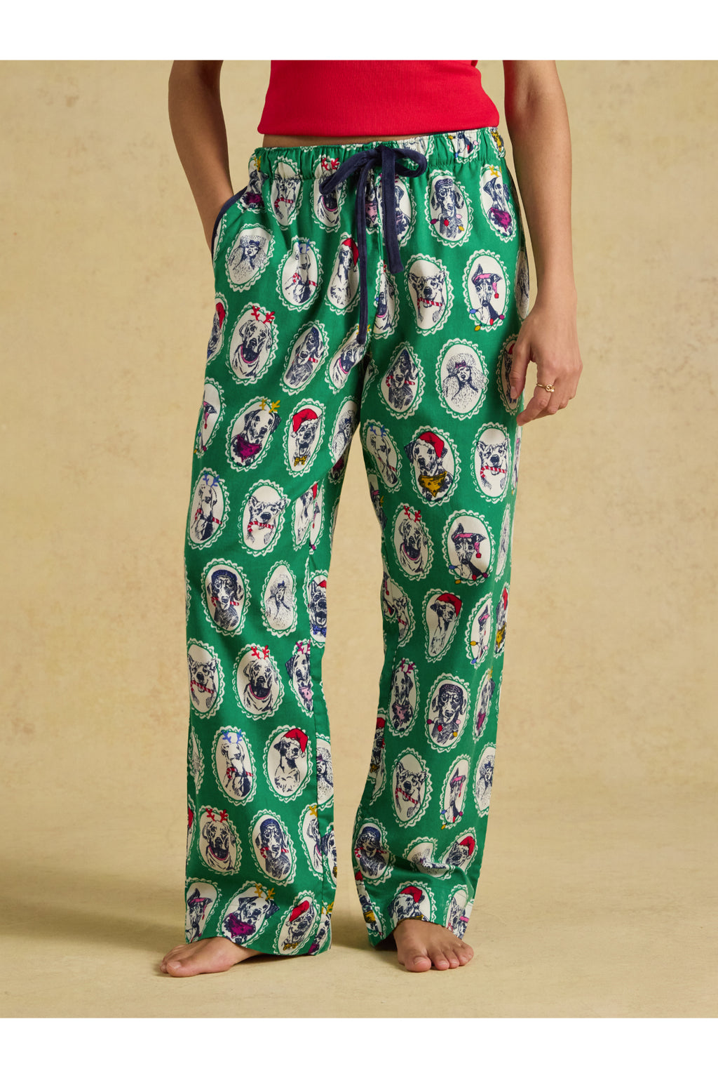 Joules Stella Green Dog Print Pyjamas worn by a model in green dog print. Shop Joules at Dotique