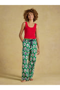 Joules Stella Green Dog Print Pyjamas worn by a model in green dog print bottoms. Shop Joules at Dotique