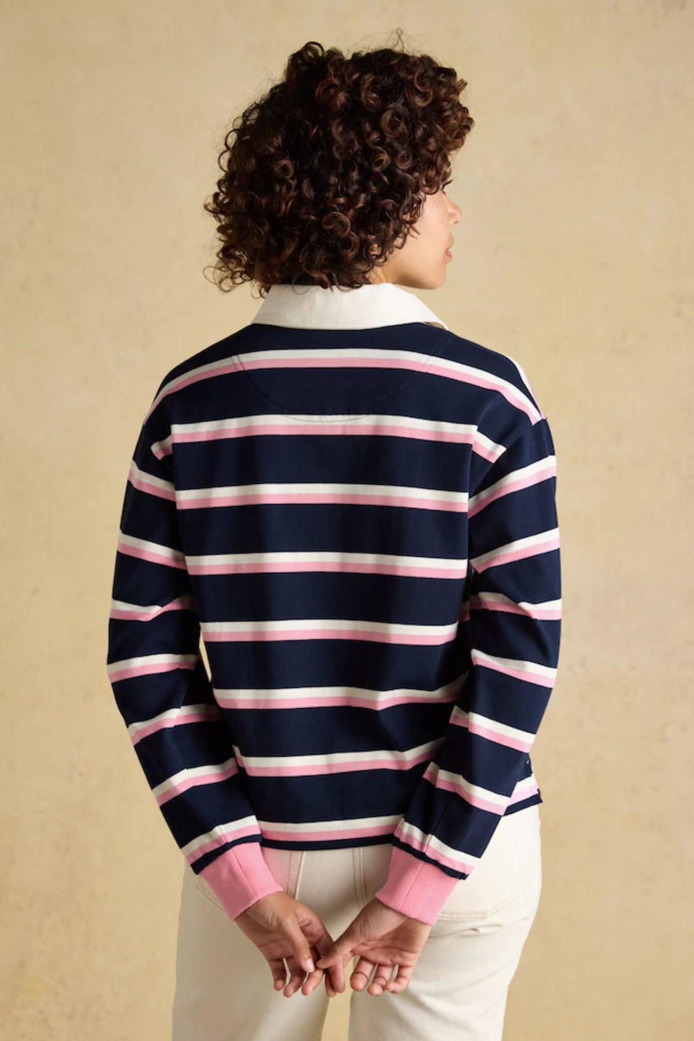 Model wearing Joules W30854 Lara Rugby Shirt – Navy / Pink Stripe by Joules, shop Joules at Dotique.
