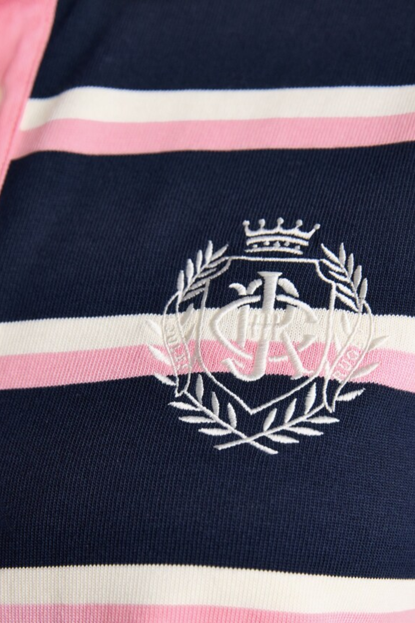 Close-up of the Joules W30854 Lara Rugby Shirt – Navy / Pink Stripe logo embroidery by Joules, shop at Dotique.