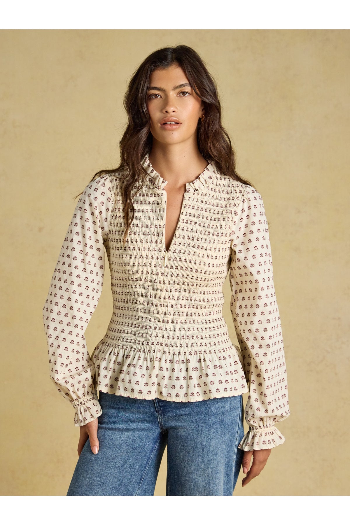Shop the Joules Zoe Blouse in Cream Ditsy at Dotique. A 100% cotton blouse with a smocked bodice, frill collar, adjustable zip and long sleeves.