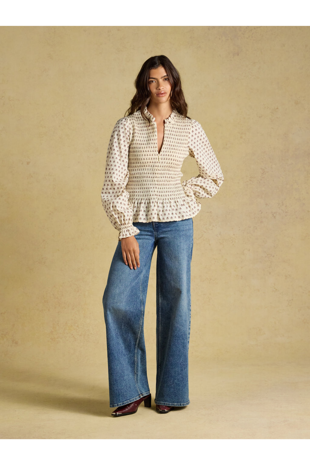 Shop the Joules Zoe Blouse in Cream Ditsy at Dotique. A 100% cotton blouse with a smocked bodice, frill collar, adjustable zip and long sleeves.