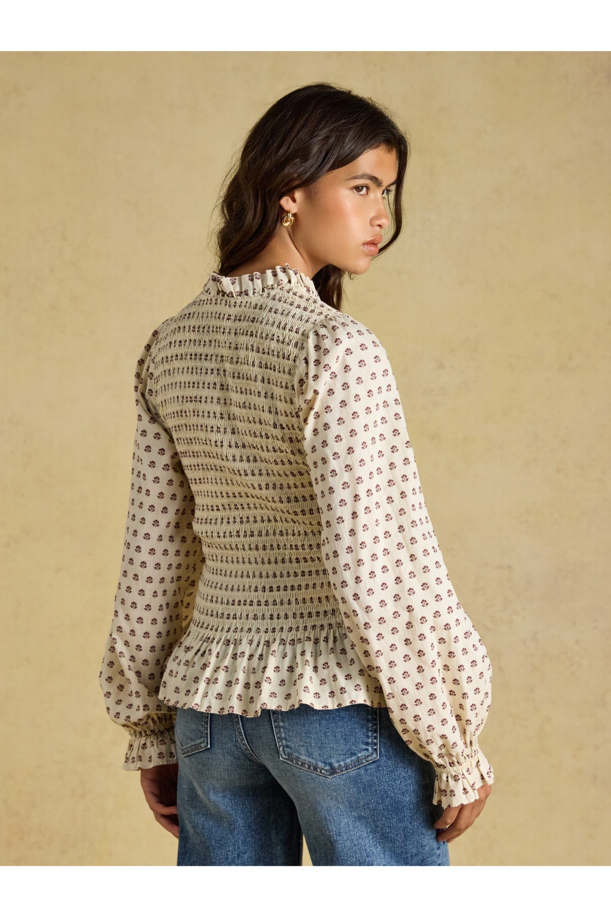 Shop the Joules Zoe Blouse in Cream Ditsy at Dotique. A 100% cotton blouse with a smocked bodice, frill collar, adjustable zip and long sleeves.