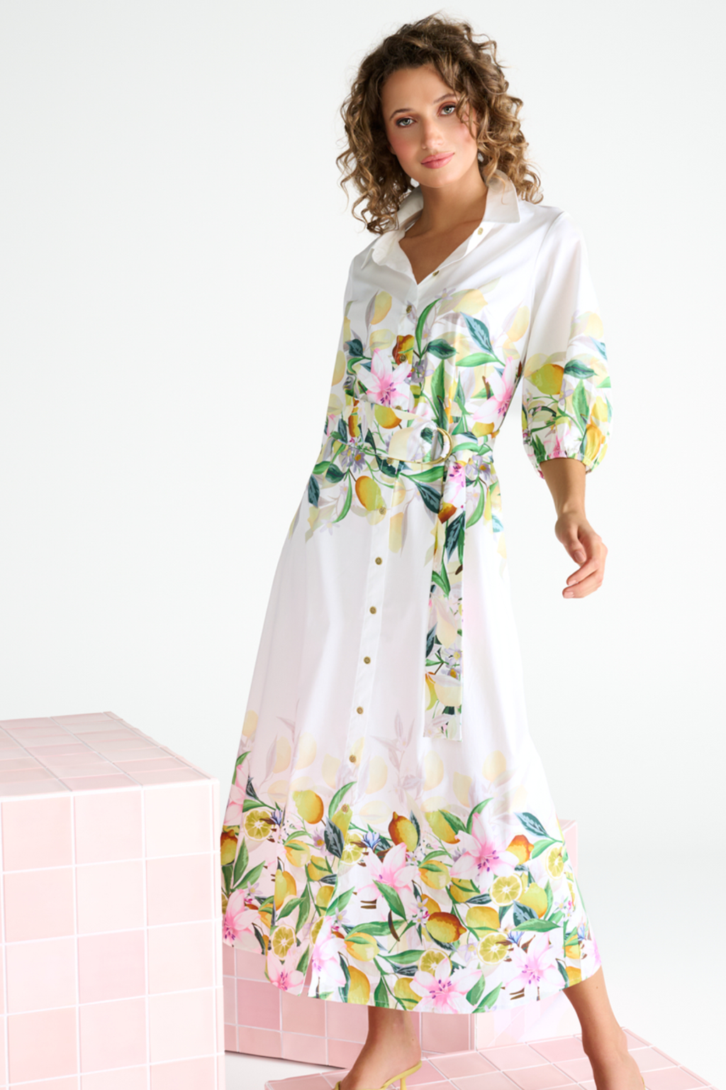 Shop K Design at Dotique. White dress with fruit and floral print. Long sleeves and midi length button up. 