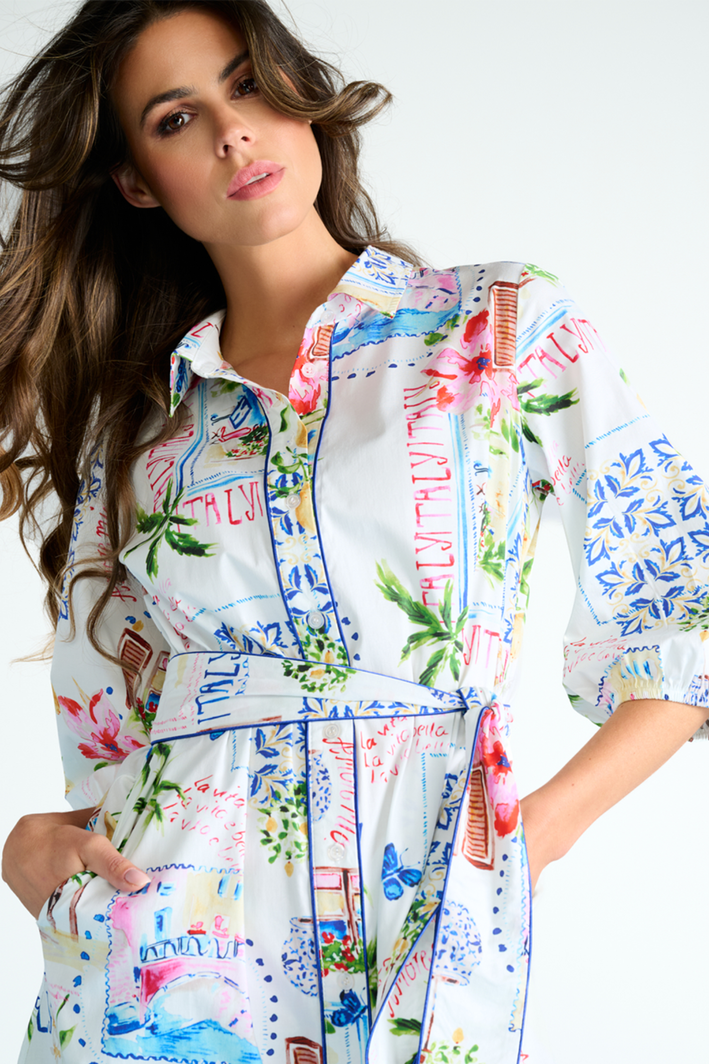Woman wearing a colorful floral dress with a white background
