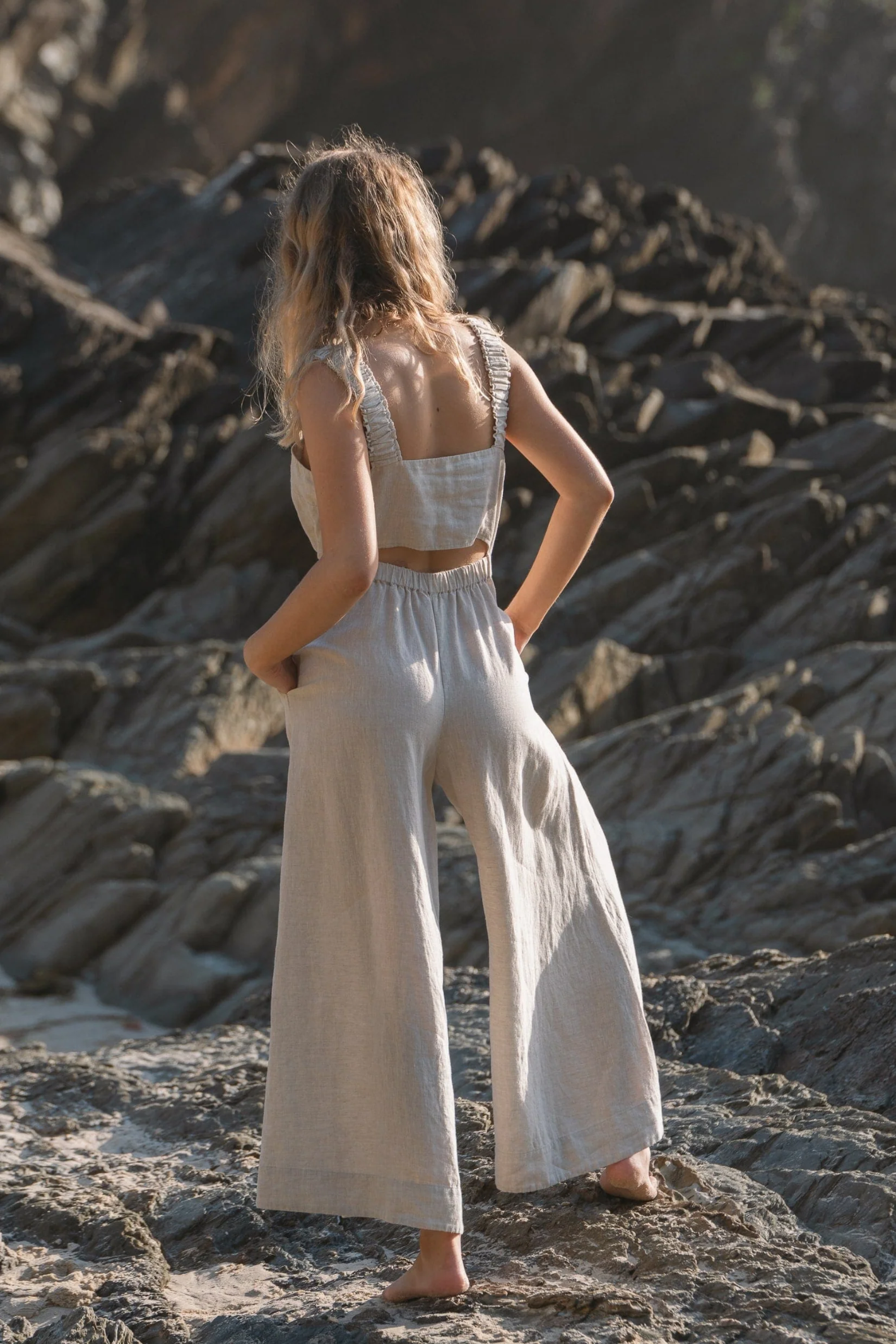 Woman wearing Lilly Pilly LPS23-D004 Keely Linen Jumpsuit Oatmeal by Lilly Pilly, shop the vendor at Dotique outdoors.
