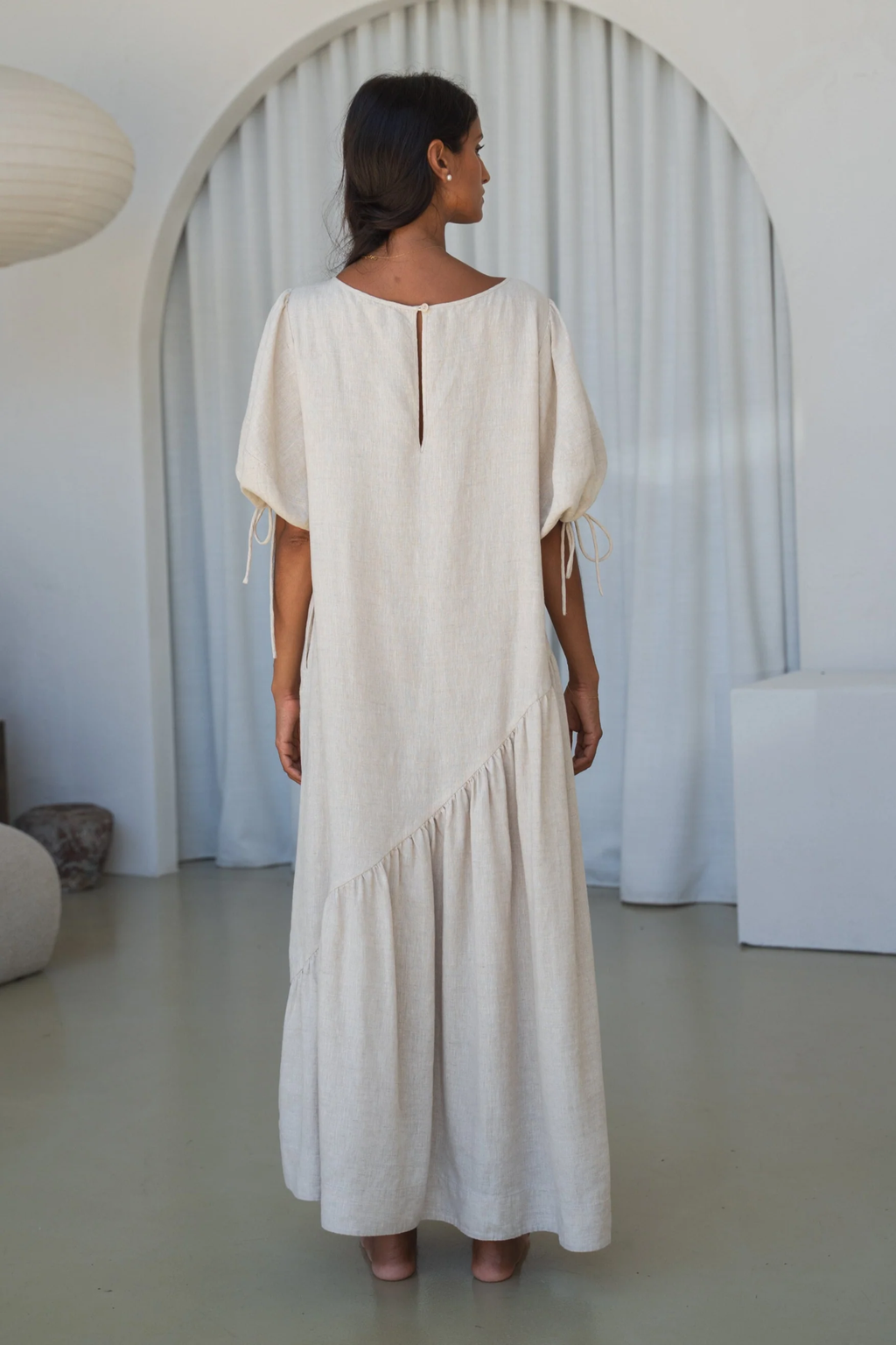 Woman wearing Lilly Pilly LPSS22-D002 Charlotte Linen Dress Oatmeal by Lilly Pilly, shop Lilly Pilly at Dotique.