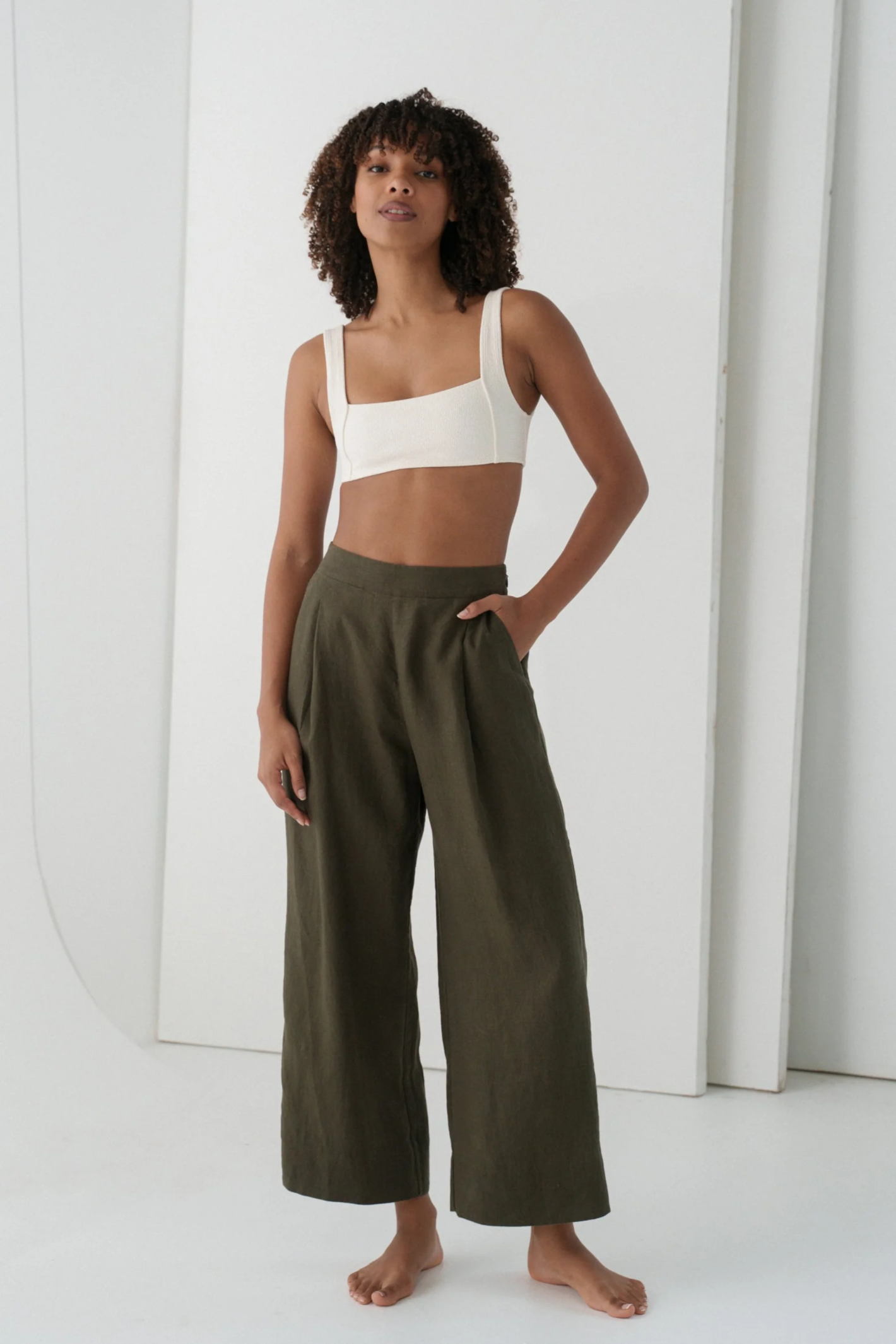 Woman wearing Lilly Pilly LPW23-P002 Ivy Linen Crop Trousers Khaki by Lilly Pilly, shop Lilly Pilly at Dotique.