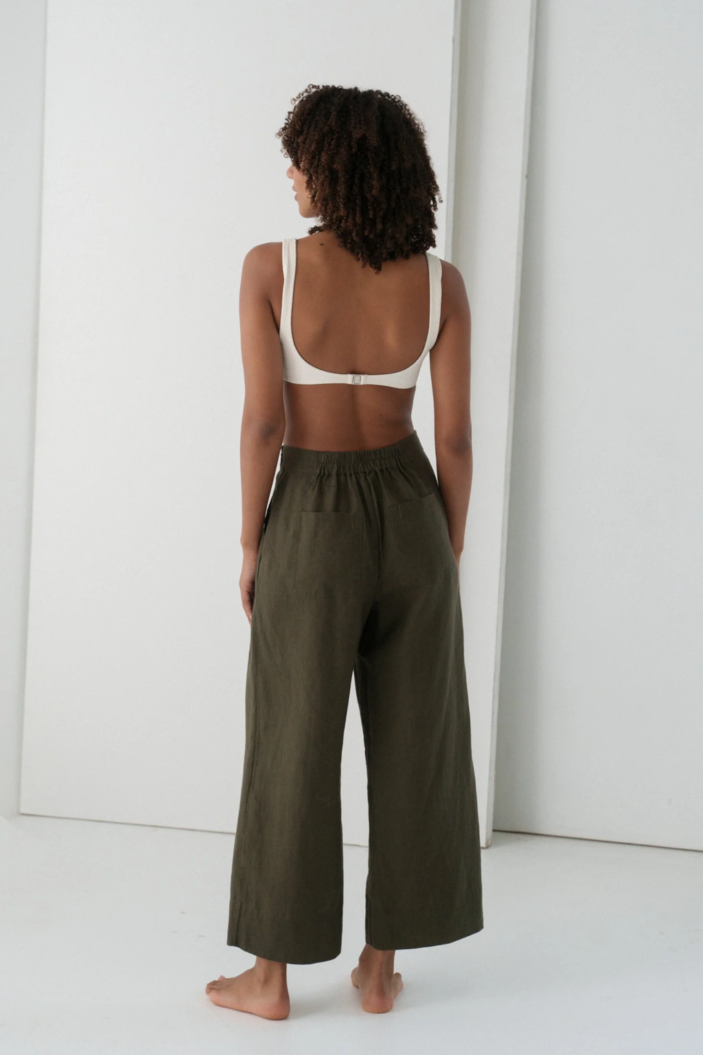 Model wearing Lilly Pilly LPW23-P002 Ivy Linen Crop Trousers Khaki by Lilly Pilly, shop Lilly Pilly at Dotique.