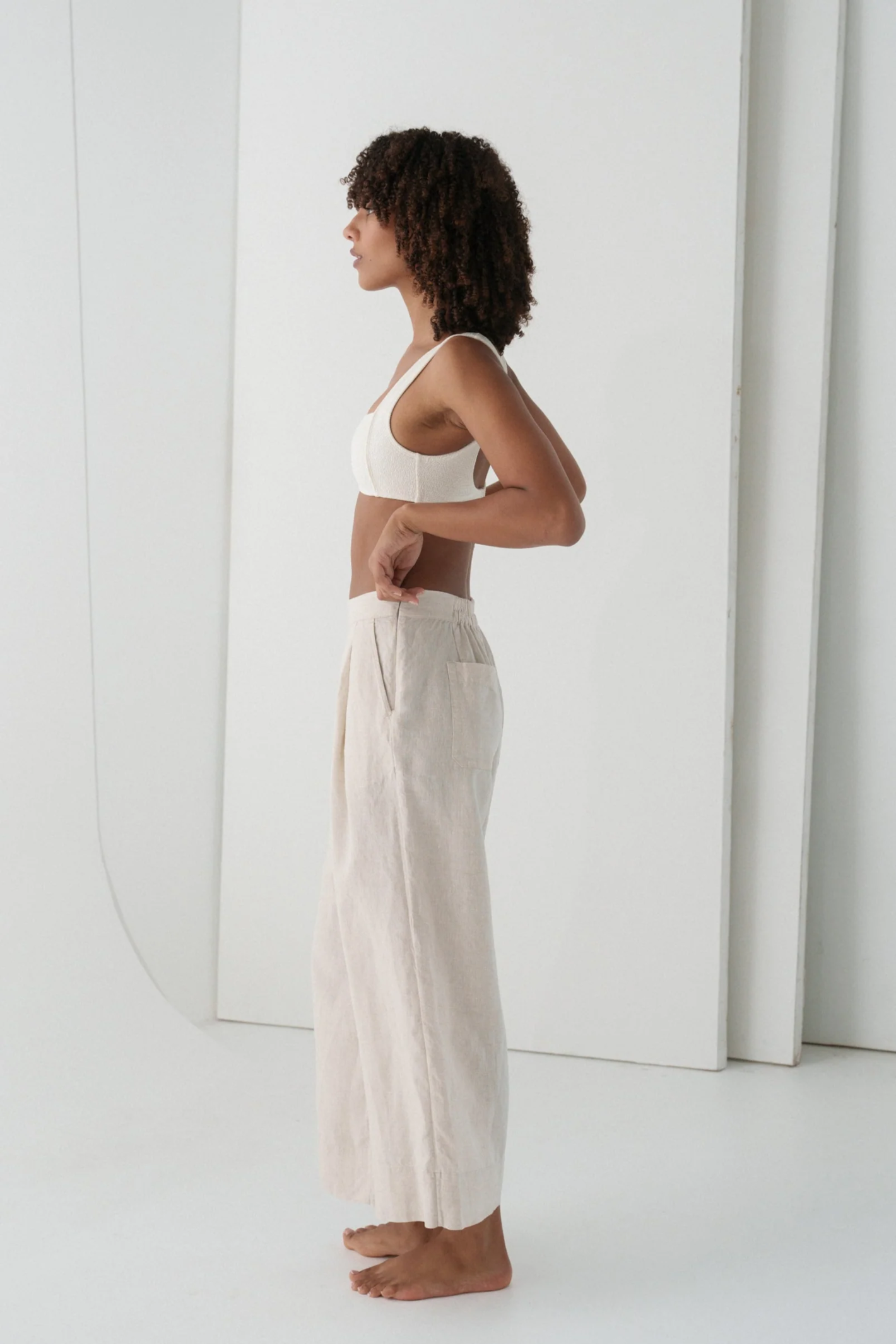 Woman wearing Lilly Pilly LPW23-P002 Ivy Linen Crop Trousers Oatmeal by Lilly Pilly, shop Lilly Pilly at Dotique.