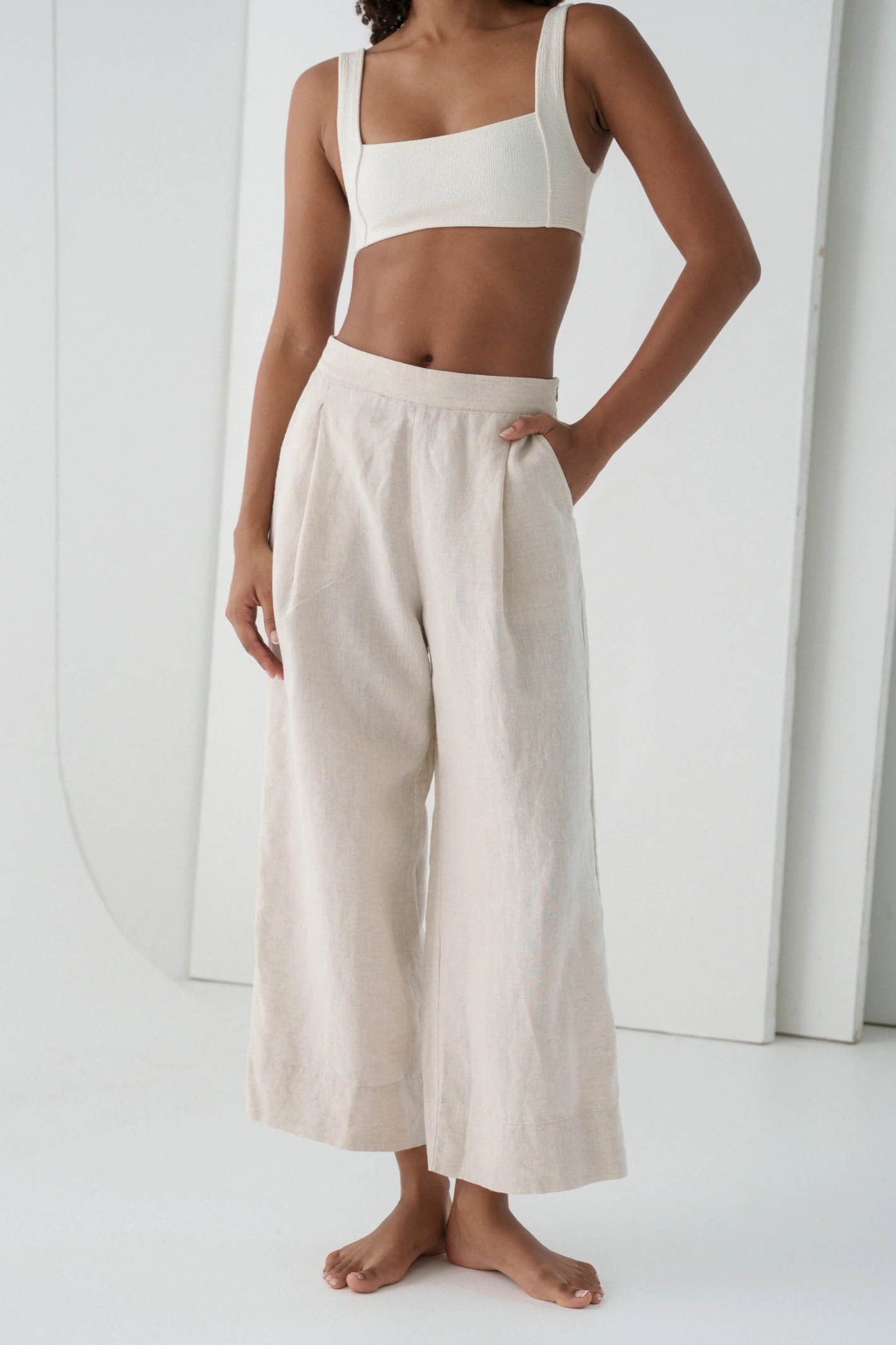 Model wearing Lilly Pilly LPW23-P002 Ivy Linen Crop Trousers Oatmeal by Lilly Pilly, shop the brand at Dotique.