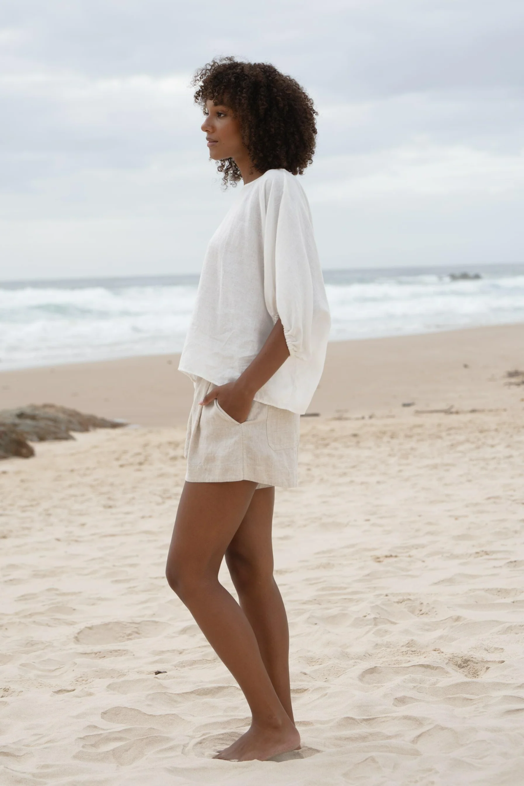 Lilly Pilly LPW23-T001 Tina Linen Top Ivory by Lilly Pilly worn by model at beach, shop Lilly Pilly at Dotique.