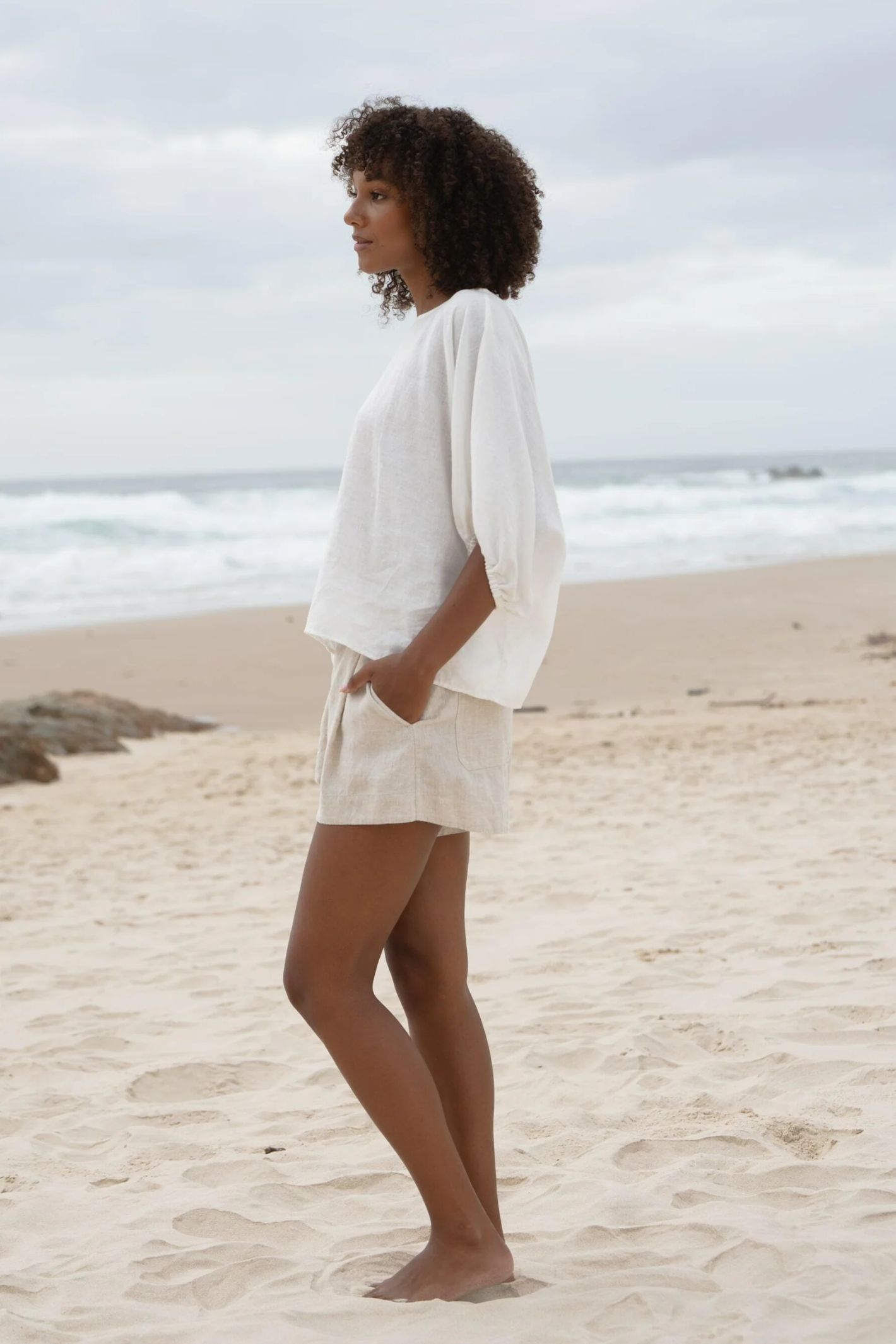 Lilly Pilly LPW23-T001 Tina Linen Top Ivory by Lilly Pilly worn by model at beach, shop Lilly Pilly at Dotique.