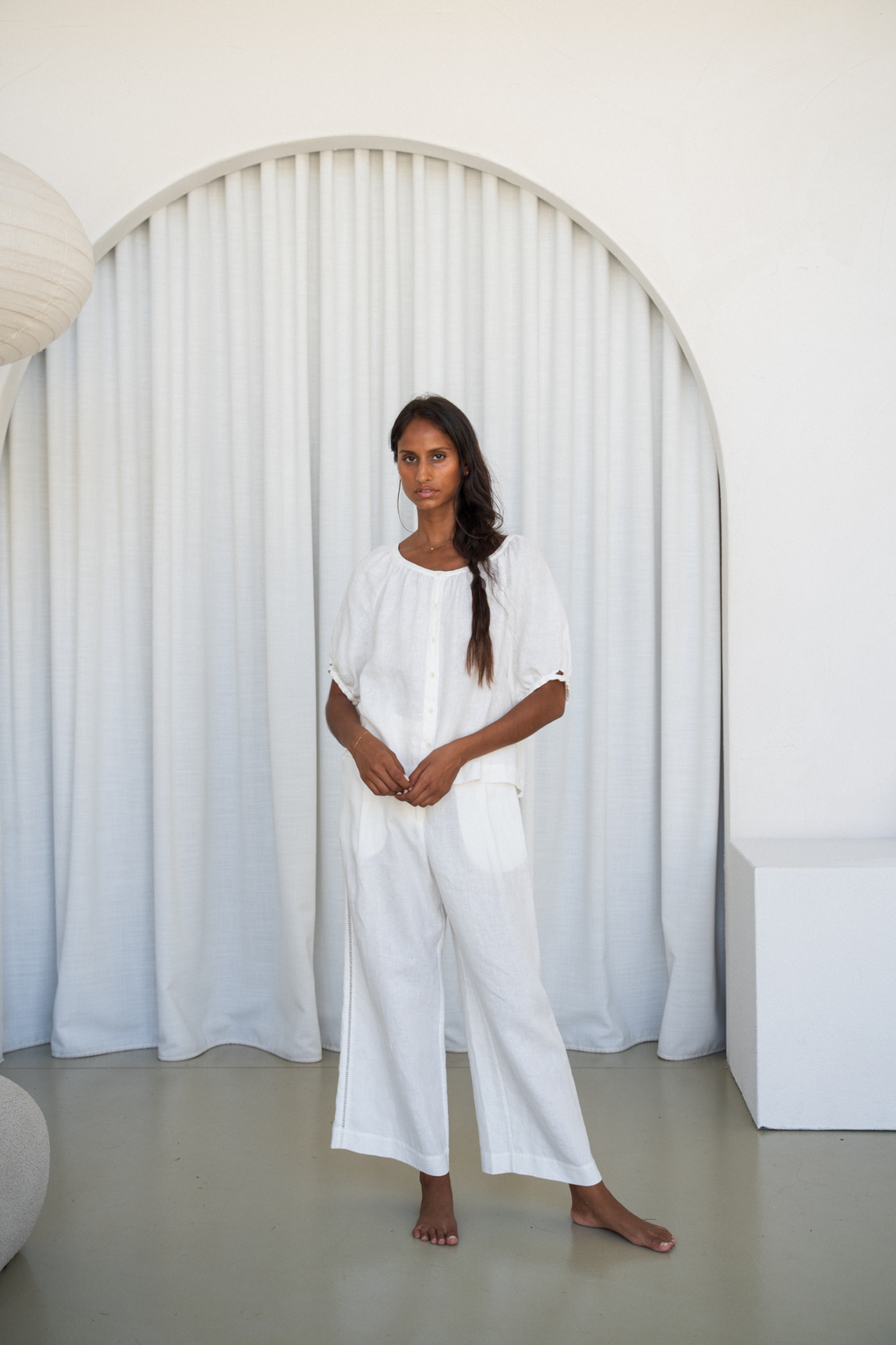 Model wearing Lilly Pilly LP-T008 Pia Linen Top Ivory by Lilly Pilly, shop Lilly Pilly at Dotique for elegant linen fashion.