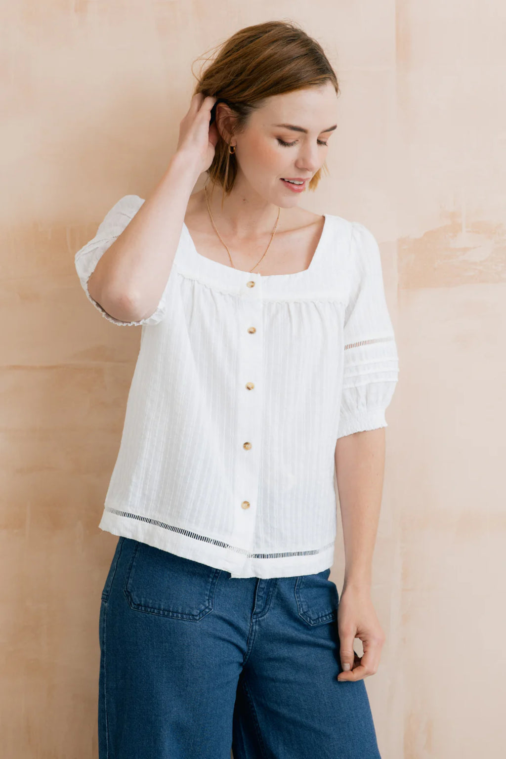 Model wearing Lily & Me LM26137 Poppy Blouse Plain Stripe Dobby White with square neckline and button front, shop Lily & me at Dotique.