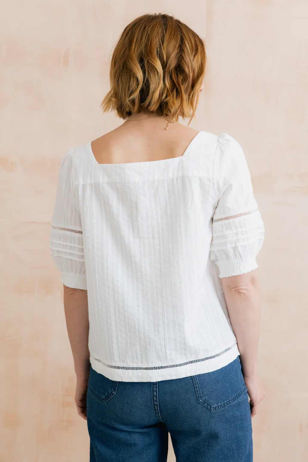 Lily & Me LM26137 Poppy Blouse Plain Stripe Dobby White shown from back with square neckline and puff sleeves, by Lily & me. Shop Lily & me at Dotique.