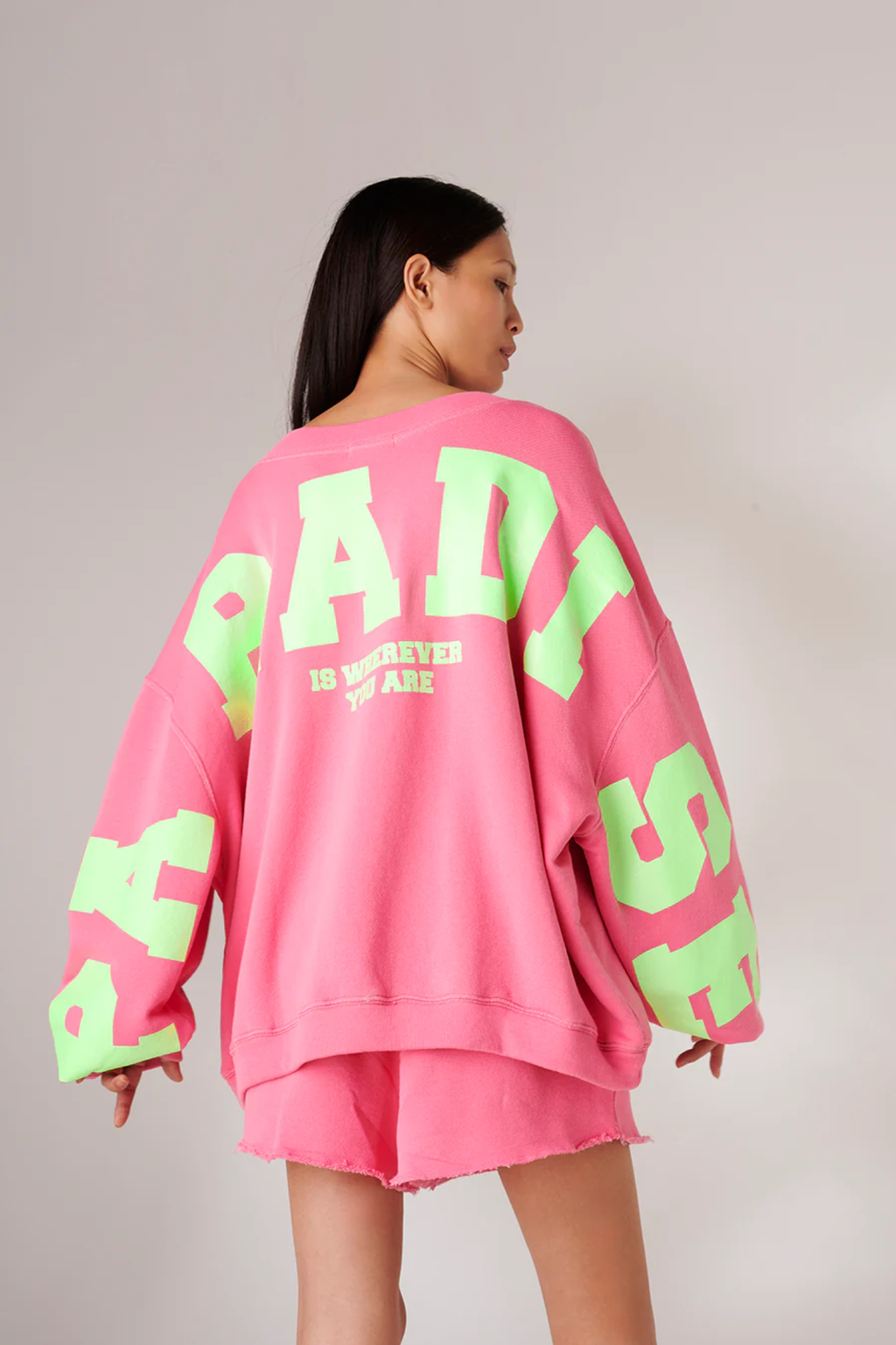 Back view of Liv Bergen Sky Paradise Sweater – Lipstick by liv bergen shop liv bergen at Dotique in bright pink with green text details