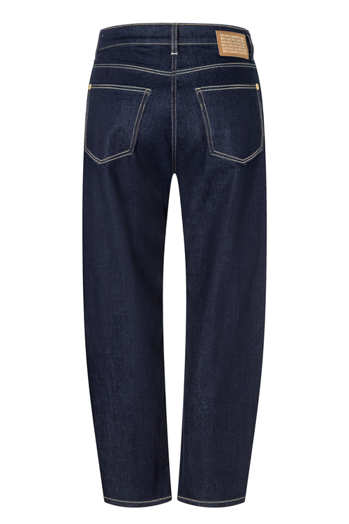 Back view of dark blue denim jeans with contrast light stitching and a tan leather patch on the back waistband, shown on a white background. Shop Mac Jeans at Dotique.